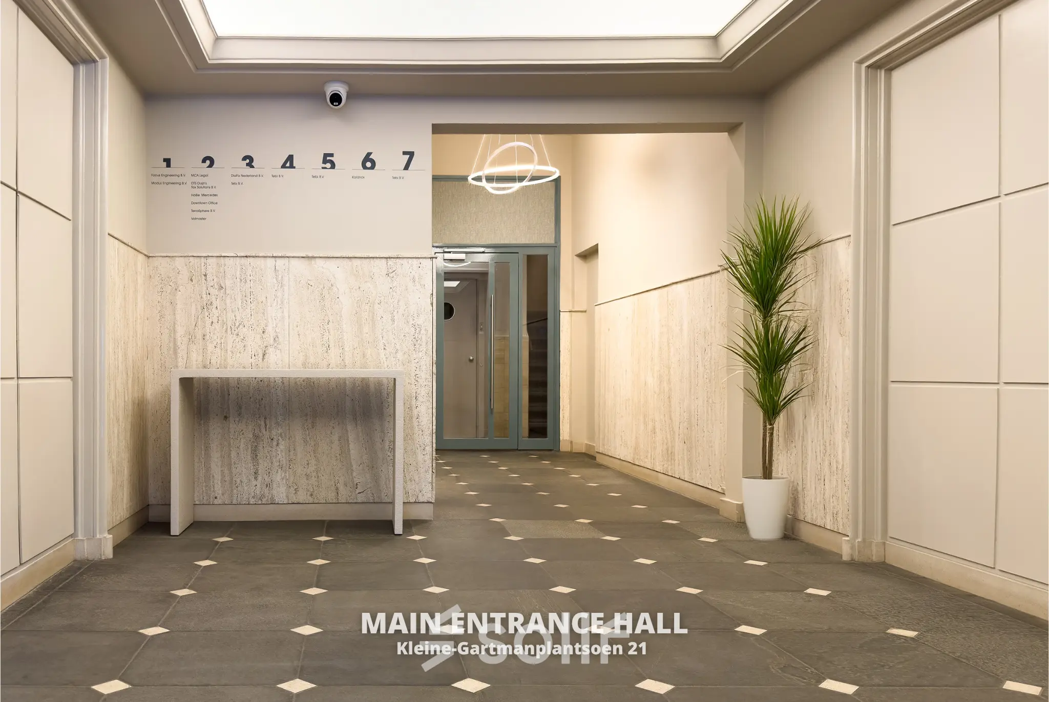 Entrance hall of an office at Kleine Gartmanplantsoen 21, Amsterdam Center, available for office space rental. Features tiled flooring and a modern light fixture.