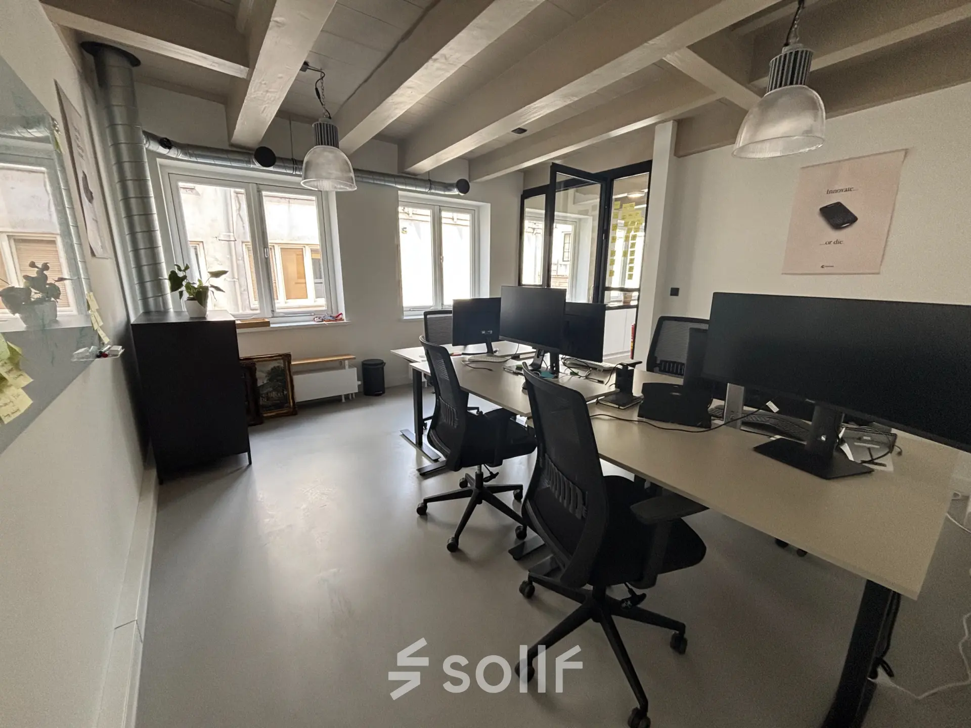 Bright office space at Kloveniersburgwal 131K, Amsterdam Center, featuring modern desks and chairs with computers, ideal for an office space rental.
