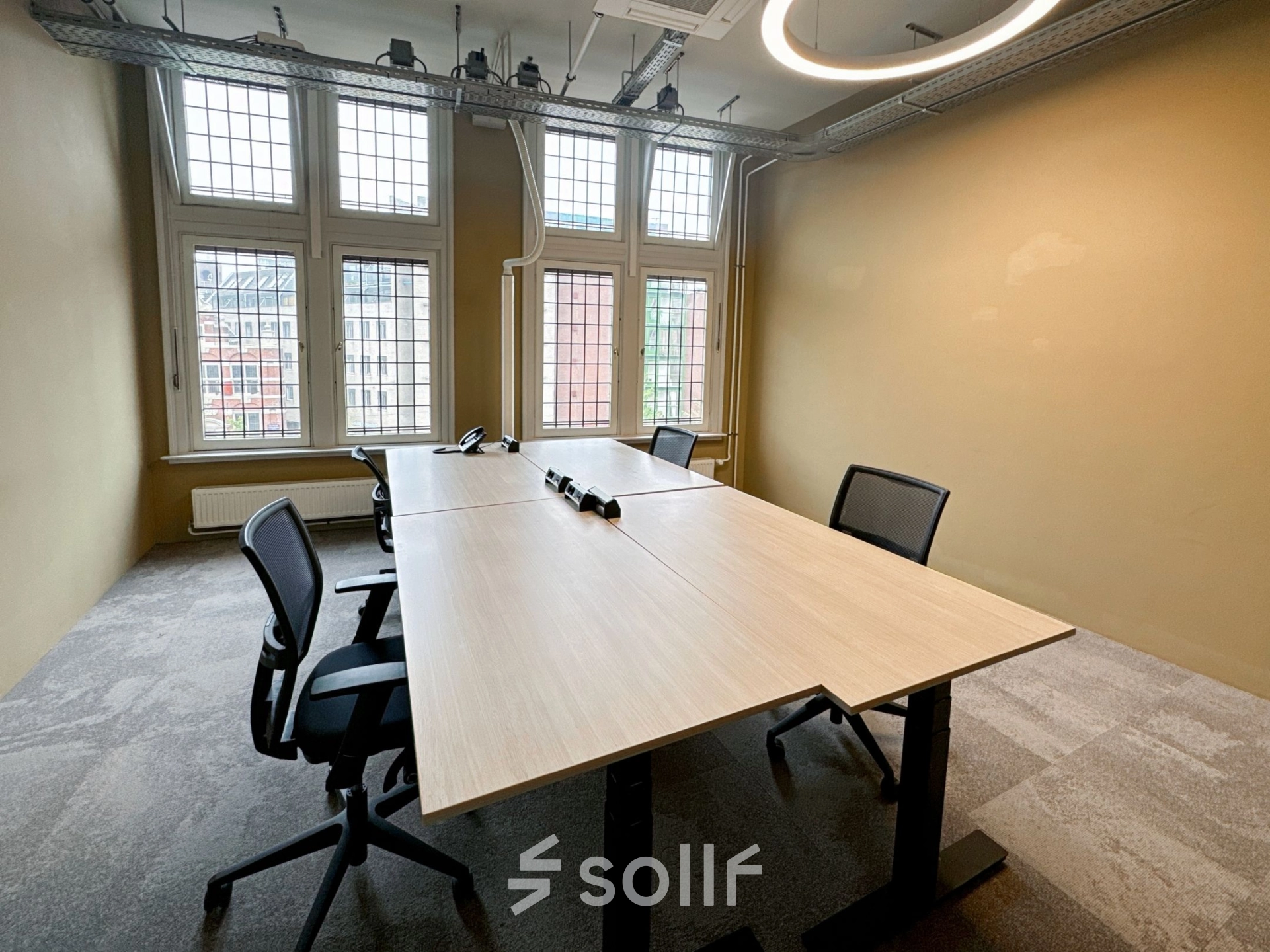 Furnished office space at Nieuwezijds Voorburgwal 104-108 in Amsterdam Center, featuring a minimalist design with tables and chairs, available for rent.