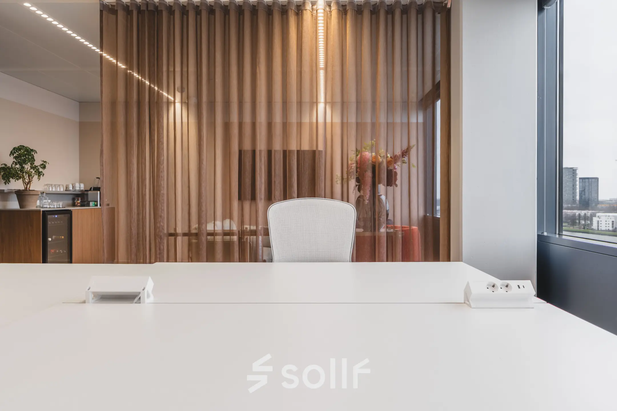 Stylish office space at Piet Heinkade 55, Amsterdam Center with a modern workspace setup and floor-to-ceiling windows, available for office space rental.