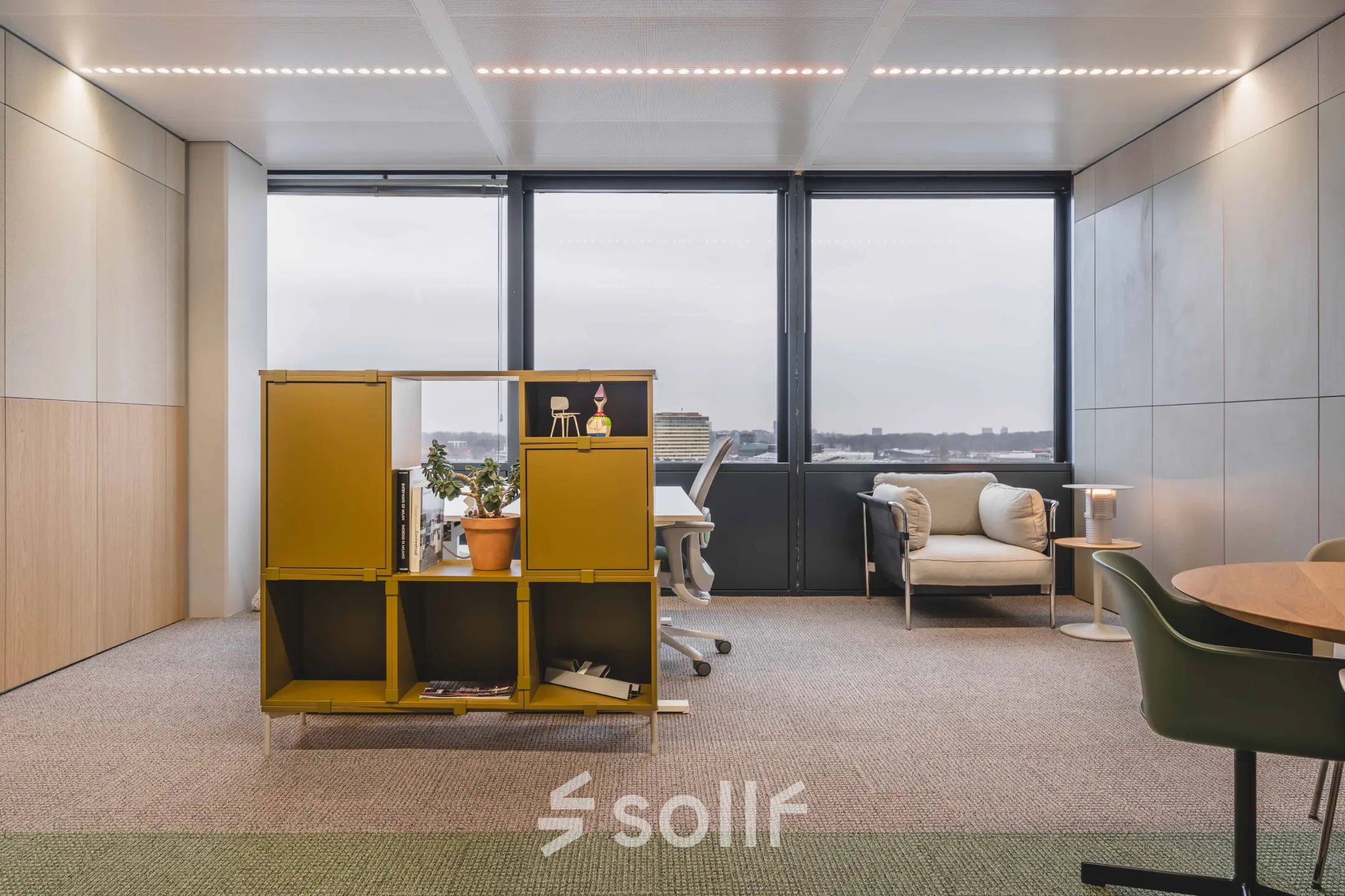 Interior of an office space for rent at Piet Heinkade 55, featuring stylish furniture and large windows with a city view.