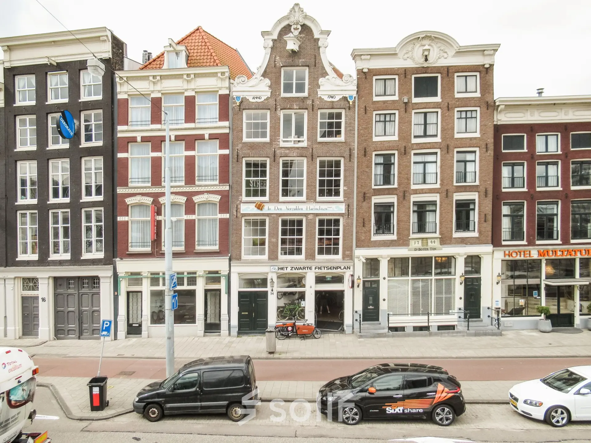 Street view of Prins Hendrikkade 14 in Amsterdam Center, showcasing historic buildings ideal for office space rental.