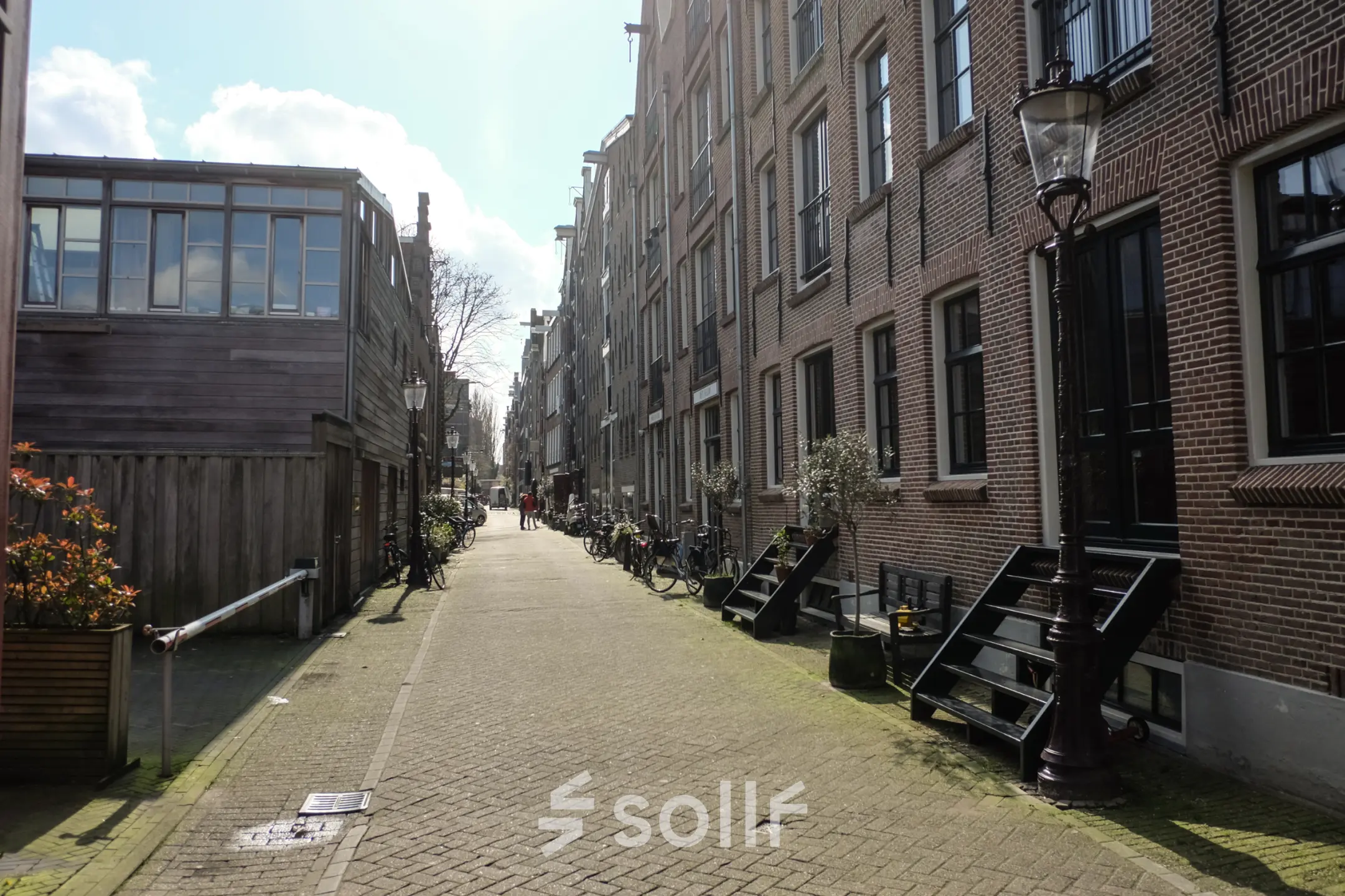 Exterior view of the office location at Prinseneiland 23A, Amsterdam Center, showcasing a charming canal-side street ideal for an office space rental.