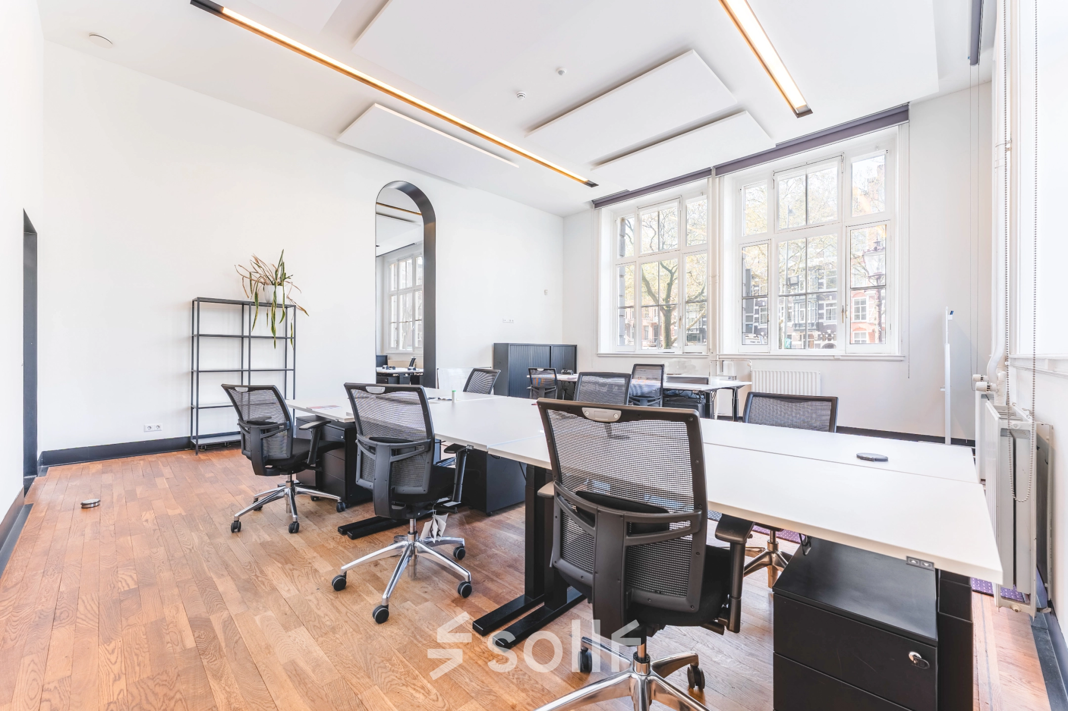 Spacious office space at Raamplein 1, Amsterdam Center, featuring sleek desks and chairs in a bright, modern setting, perfect for office space rental.