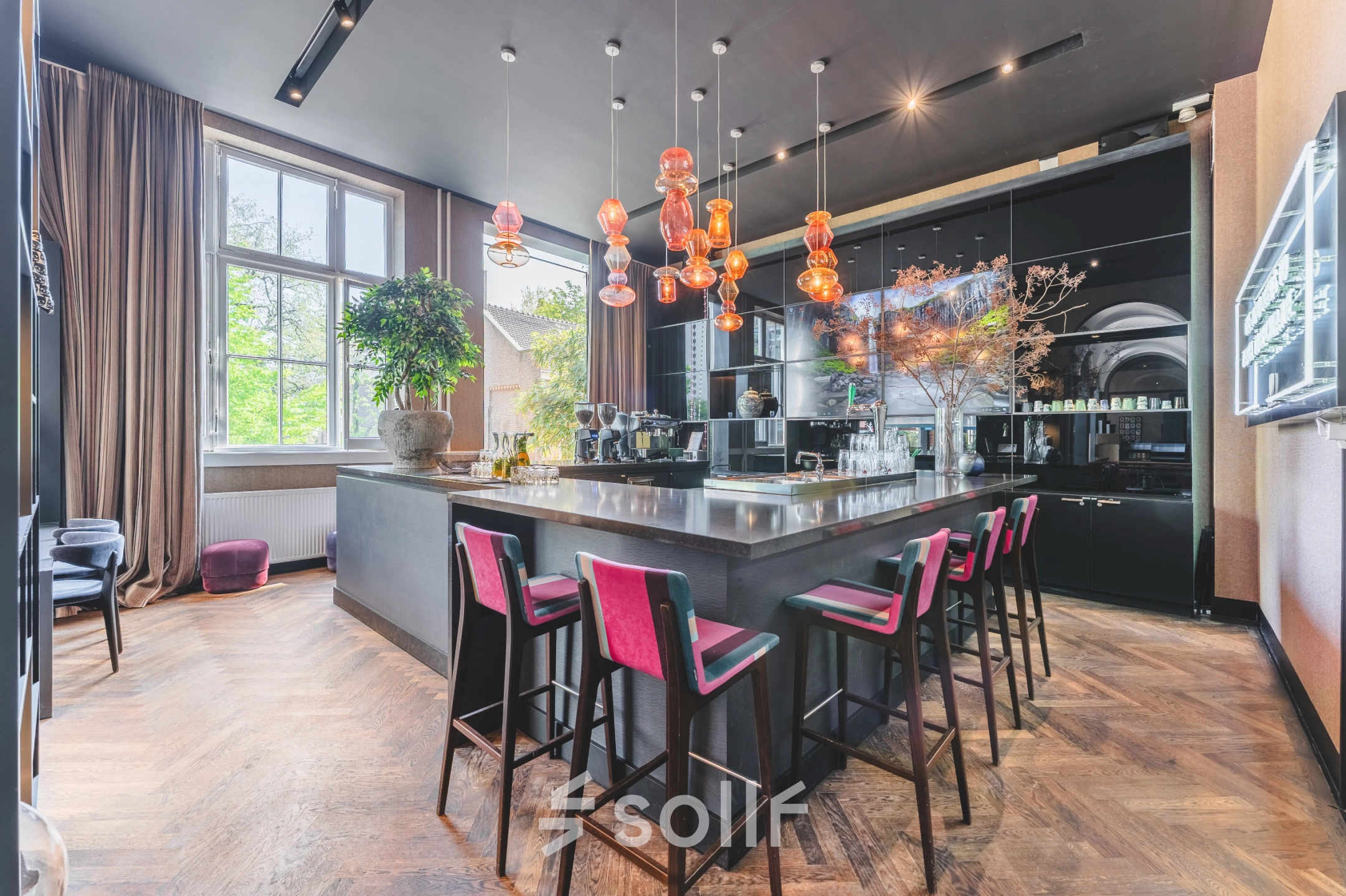 Modern furnished office space with a stylish bar area, located at Raamplein 1, Amsterdam Center, available for office space rental.