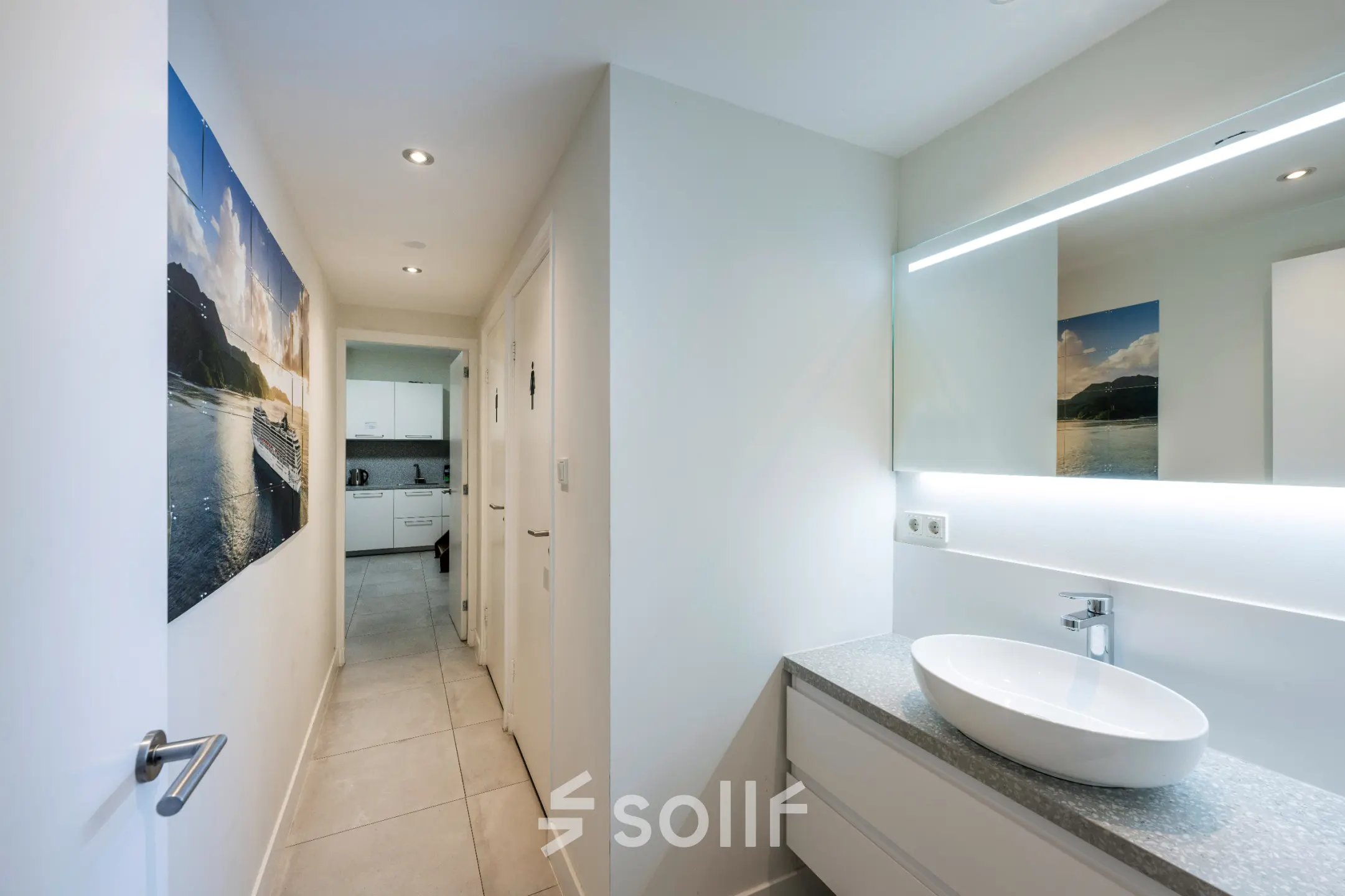 Modern office space with a sleek, furnished interior featuring a hallway leading to a pantry area at Rokin 105 105, Amsterdam Center, ideal for office space rental.