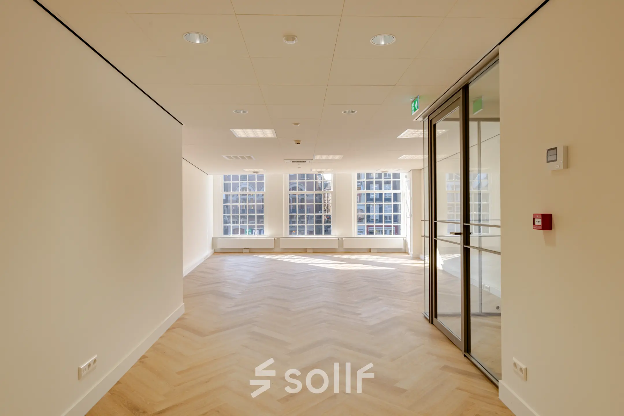 Spacious office space rental at Rokin 117, 117 in Amsterdam Center with large windows and wooden floors. Ideal for businesses seeking an office to rent.