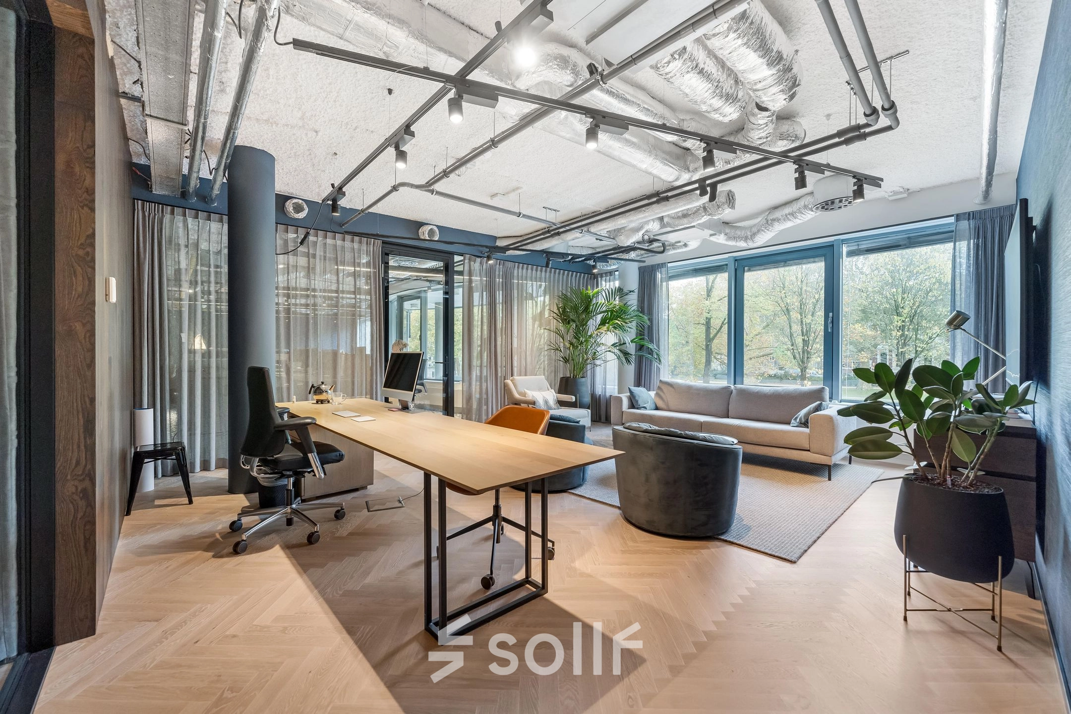 Modern office space with stylish furnishings and large windows at Stadhouderskade 55, ideal for an office to rent in Amsterdam Center.