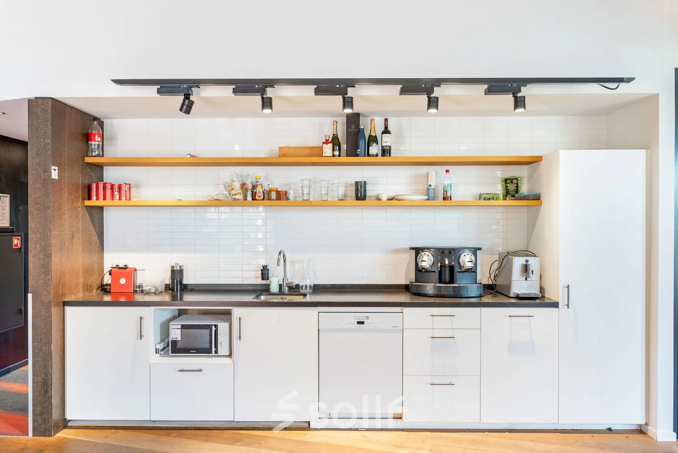 Modern pantry area at Stadhouderskade 55 with appliances and shelves, ideal for office space rental in Amsterdam Center.