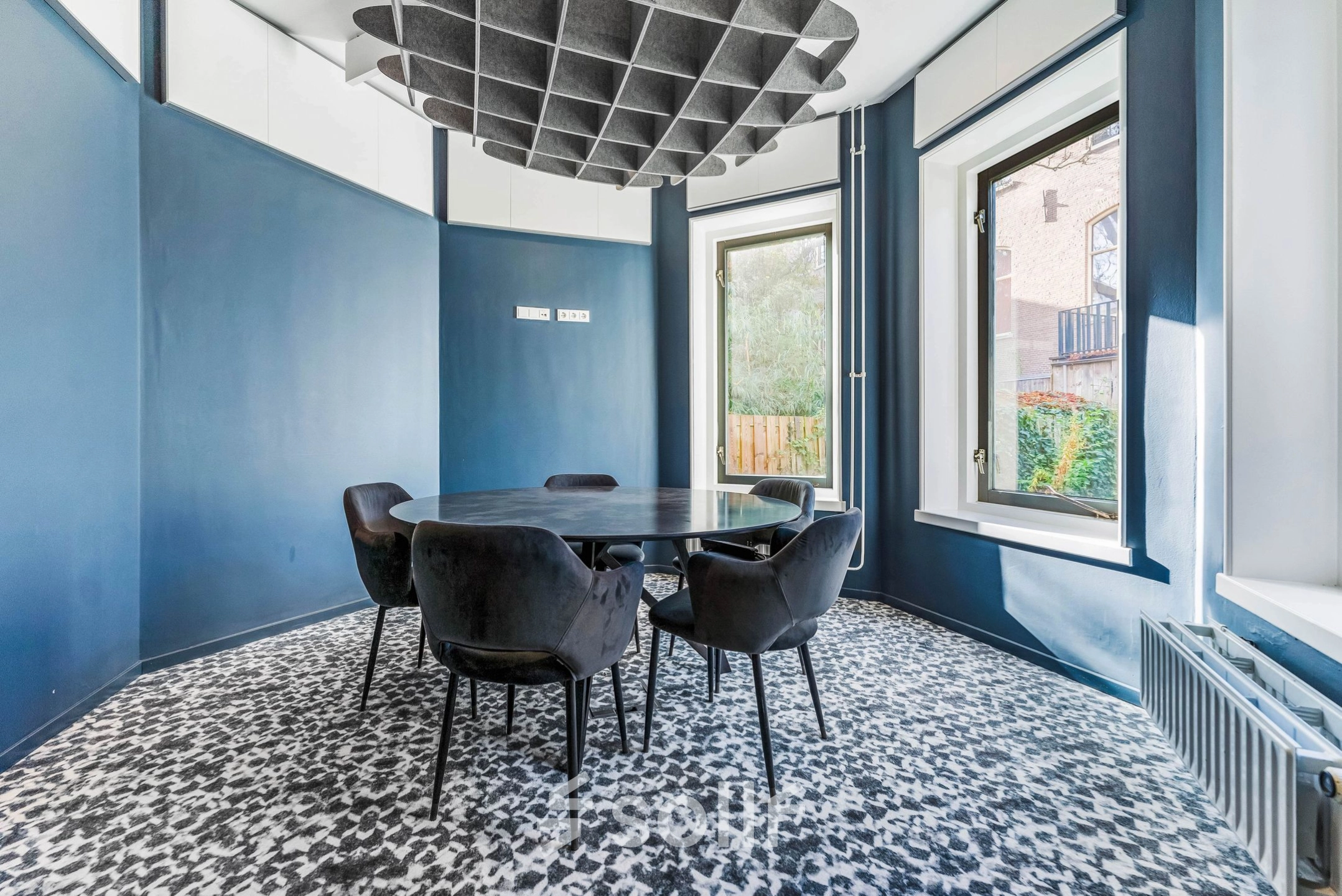 Modern office to rent at Stadhouderskade 55, Amsterdam Center, featuring a stylish meeting room with a round table and plush chairs.