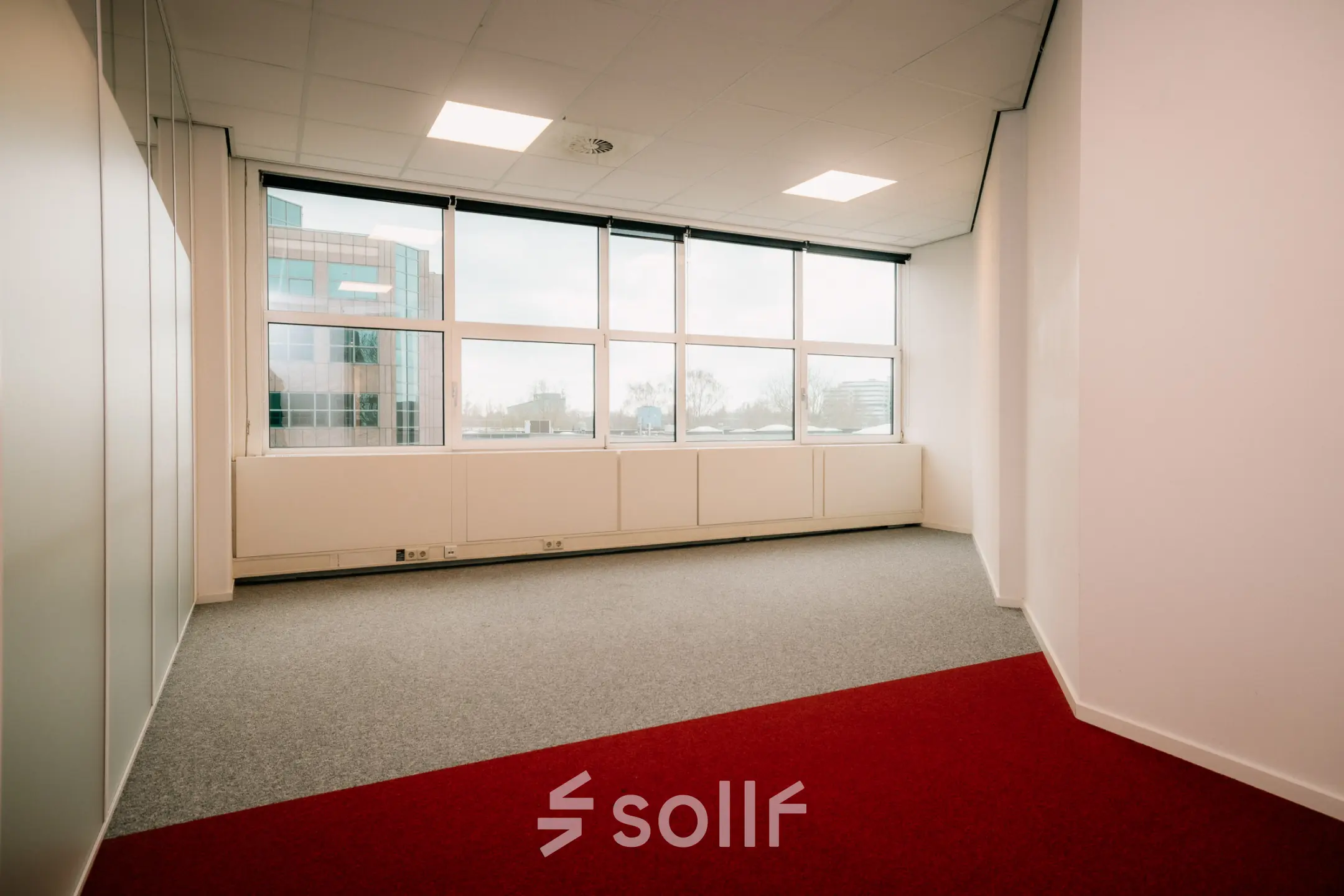 Unfurnished office space at Overschiestraat 182, offering natural light through large windows, ideal for office space rental in Amsterdam De Schinkel.