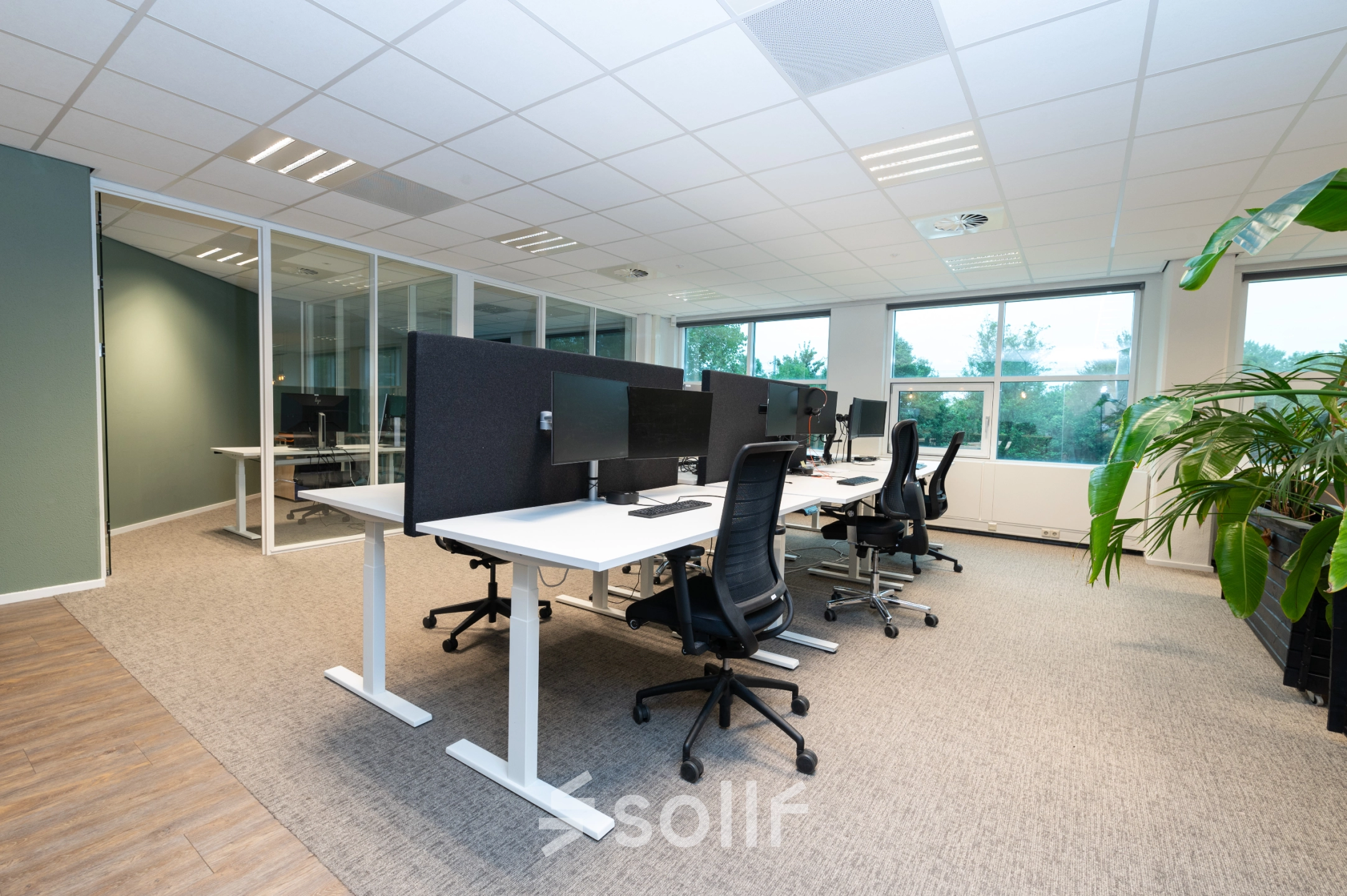 Modern office space rental at Overschiestraat 186 in Amsterdam De Schinkel, featuring furnished workspaces with desks and chairs in a bright interior.