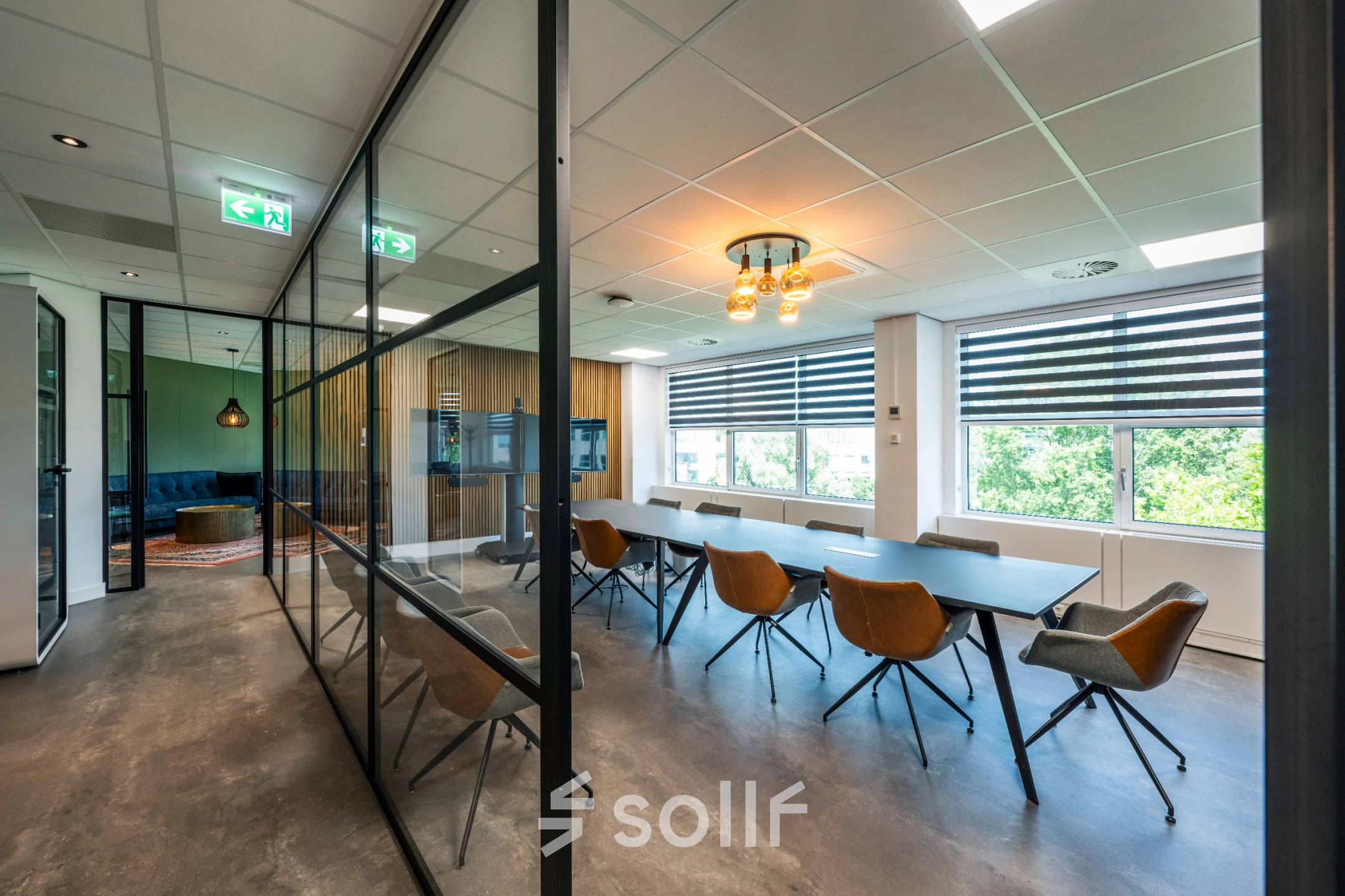 Bright office space with modern furnishings and large windows in Amsterdam De Schinkel, ideal for office space rental.