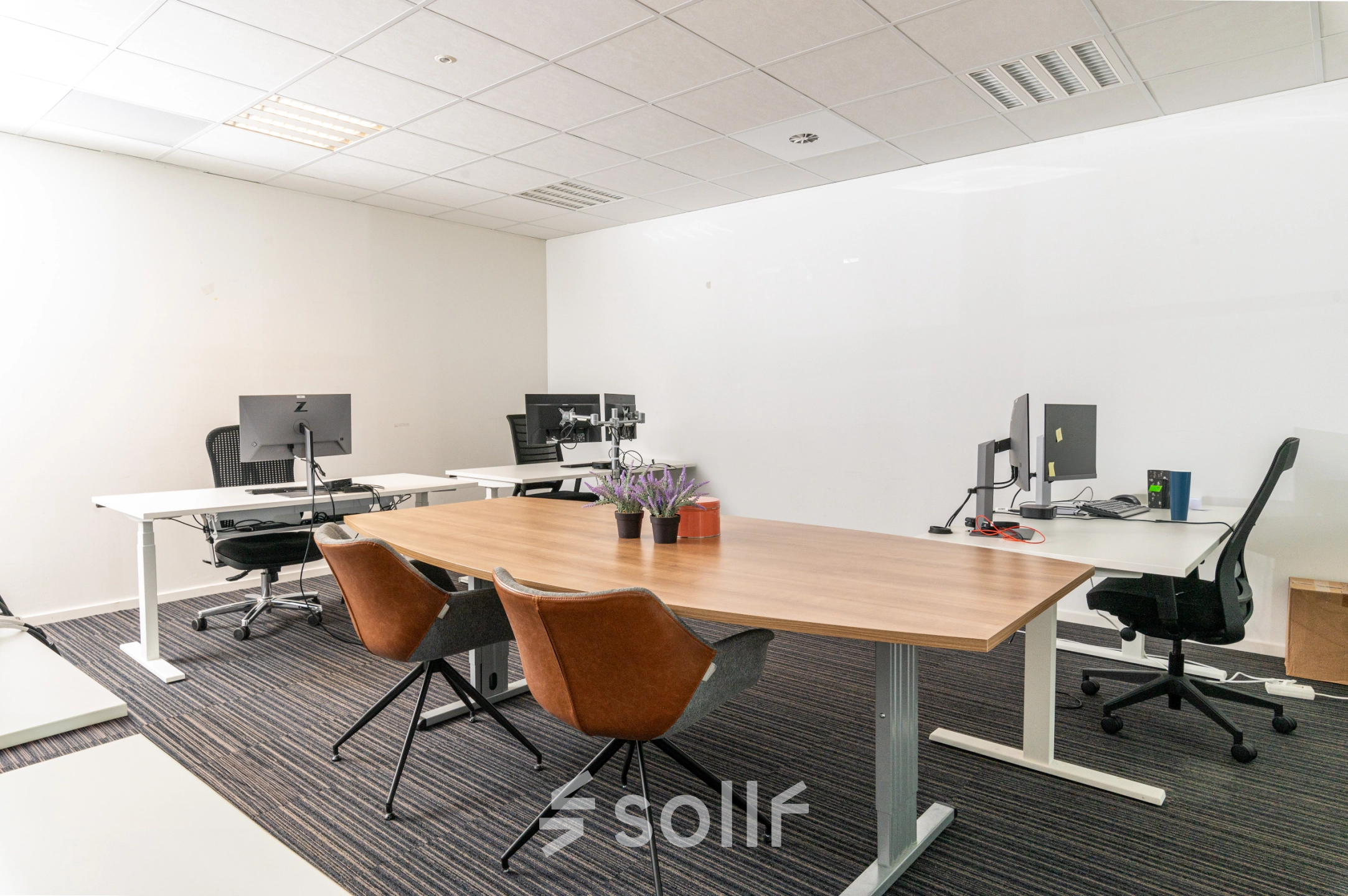 Furnished office space rental in Amsterdam De Schinkel at Overschiestraat 186 featuring desks, chairs, and computer monitors.