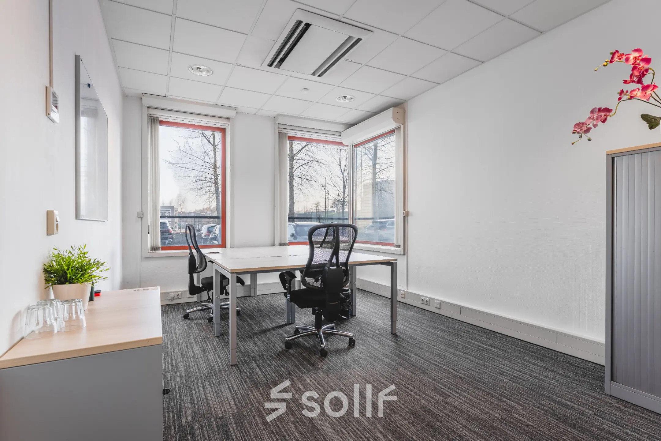 Furnished office space rental at Daalwijkdreef 47, Amsterdam Duivendrecht, featuring desks and chairs near large windows.