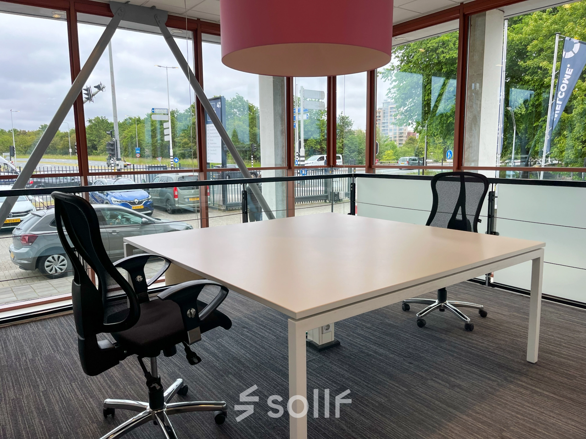 Bright office to rent in Amsterdam Duivendrecht, featuring large windows, two chairs, and a desk, ideal for office space rental.