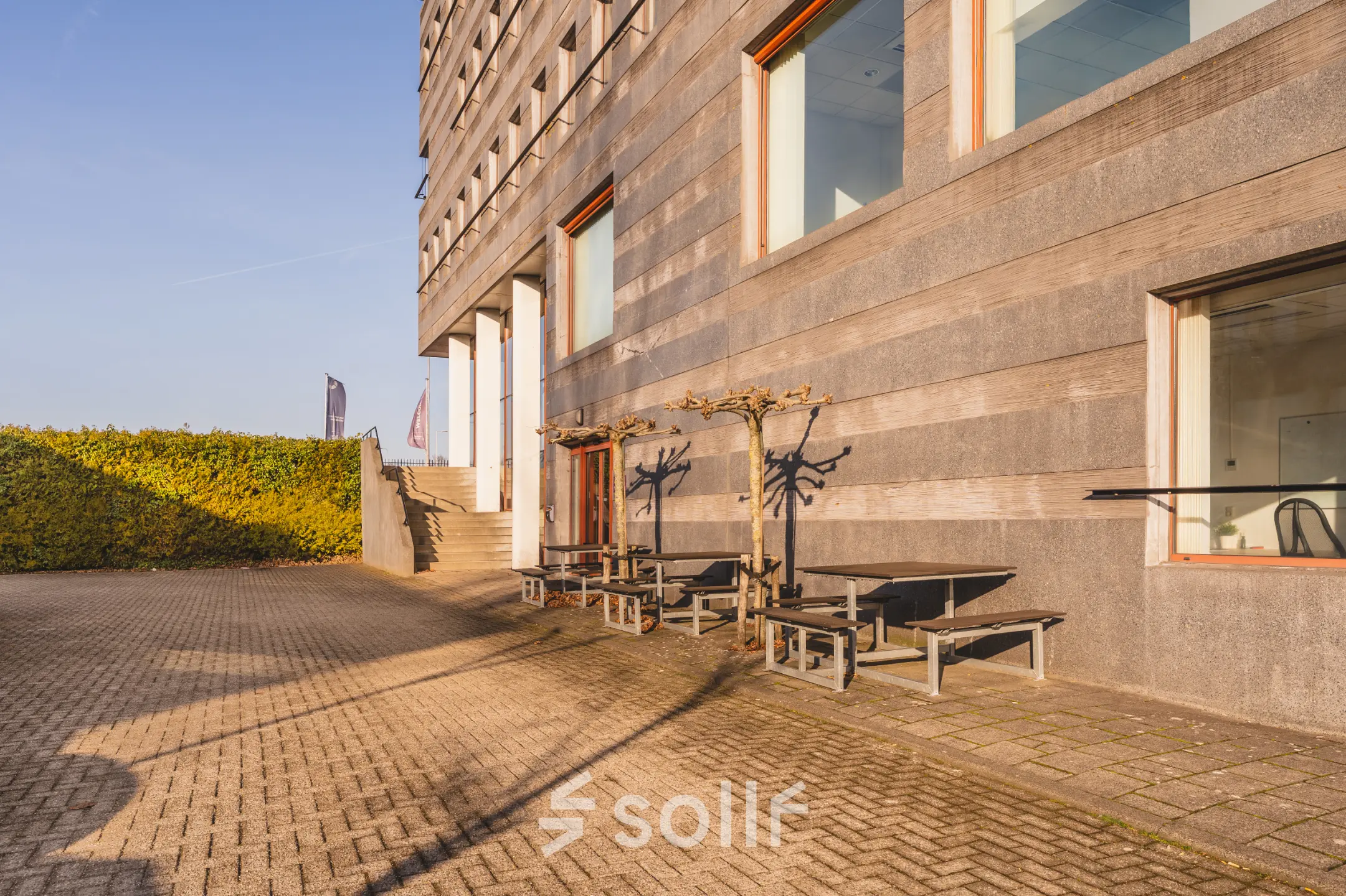 Exterior of Daalwijkdreef 47 in Amsterdam Duivendrecht featuring modern architecture and outdoor seating, ideal for an office space rental.