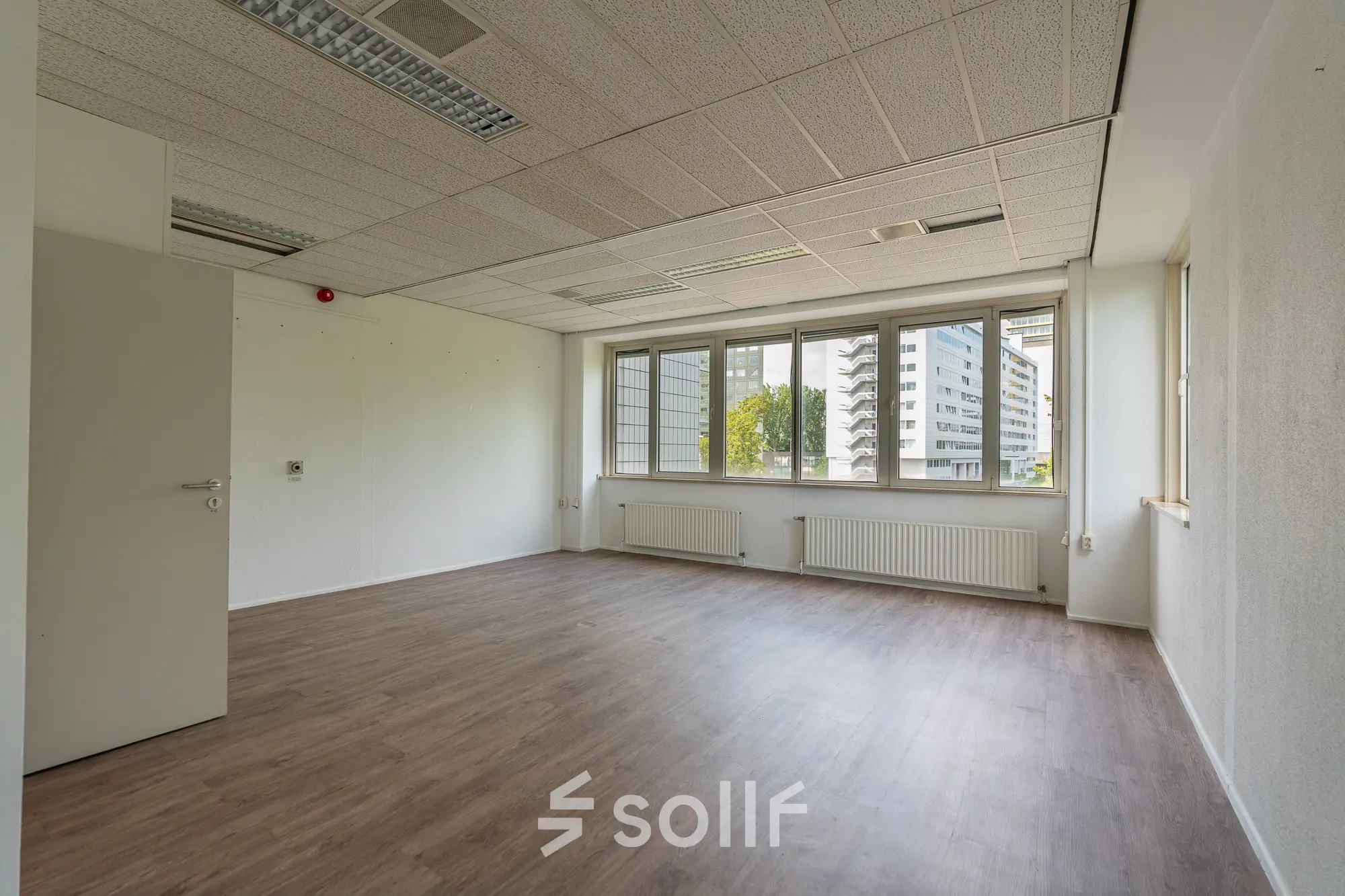 Bright office space with large windows offering natural light, located at James Wattstraat 71 in Amsterdam East, suitable for office space rental.