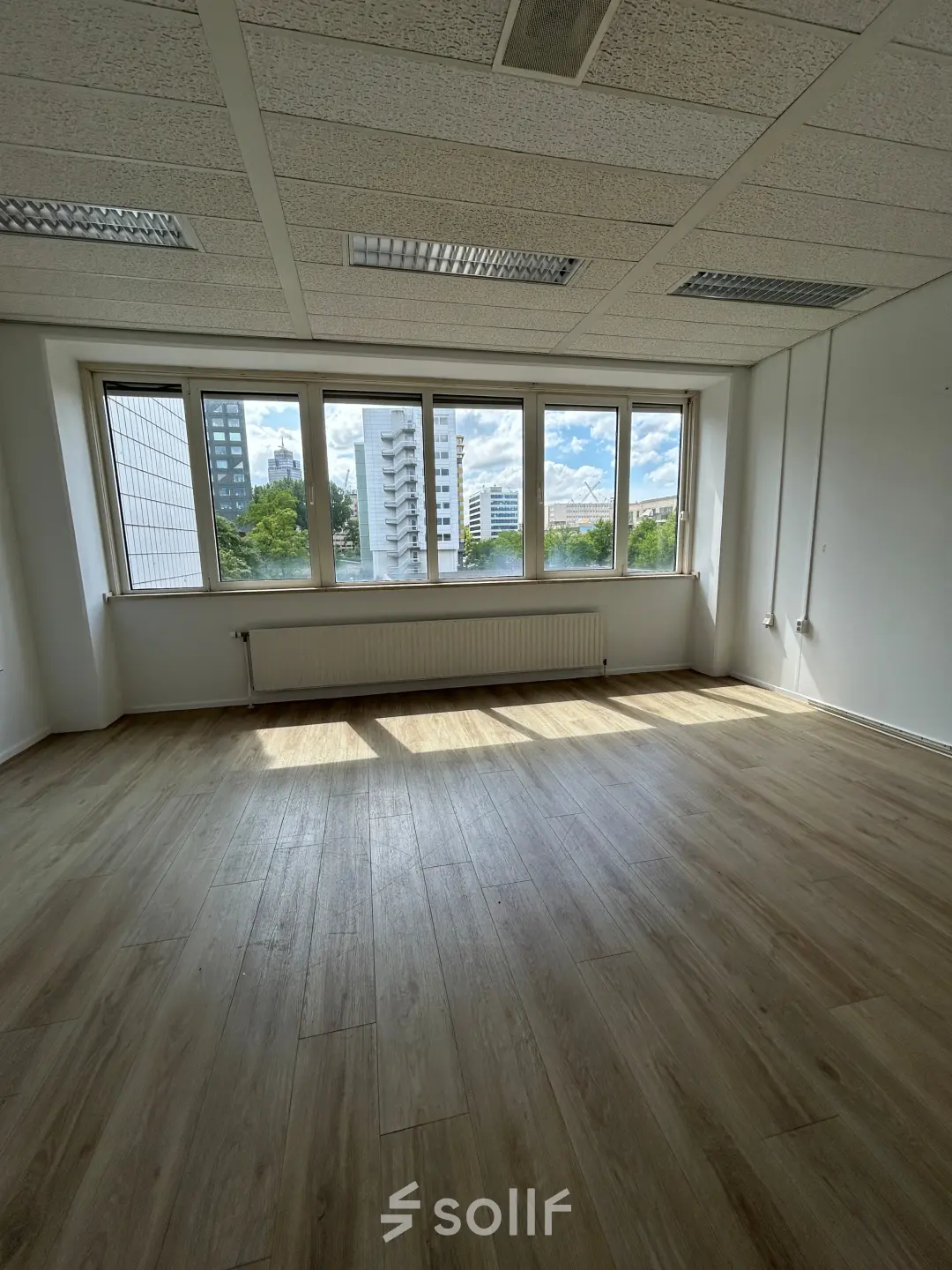 A bright, unfurnished office space with large windows at James Wattstraat 71, Amsterdam East. Ideal for office space rental with a view.