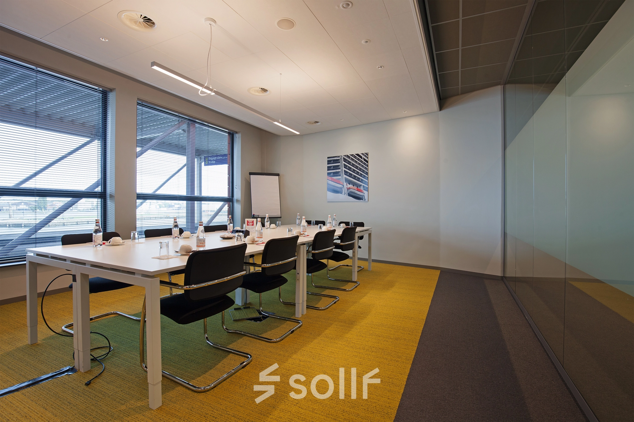 Modern conference room with long table and chairs at Piet Heinkade 55, Amsterdam East, ideal for office space rental.