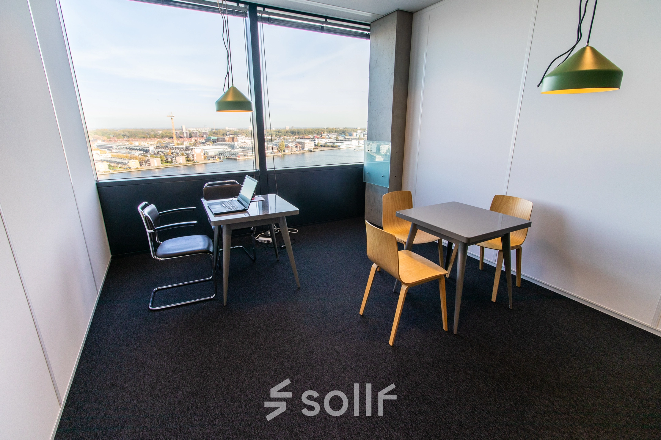 Bright office space for rent at Piet Heinkade 55, Amsterdam East, featuring modern furnishings and a stunning view, ideal for work and meetings.