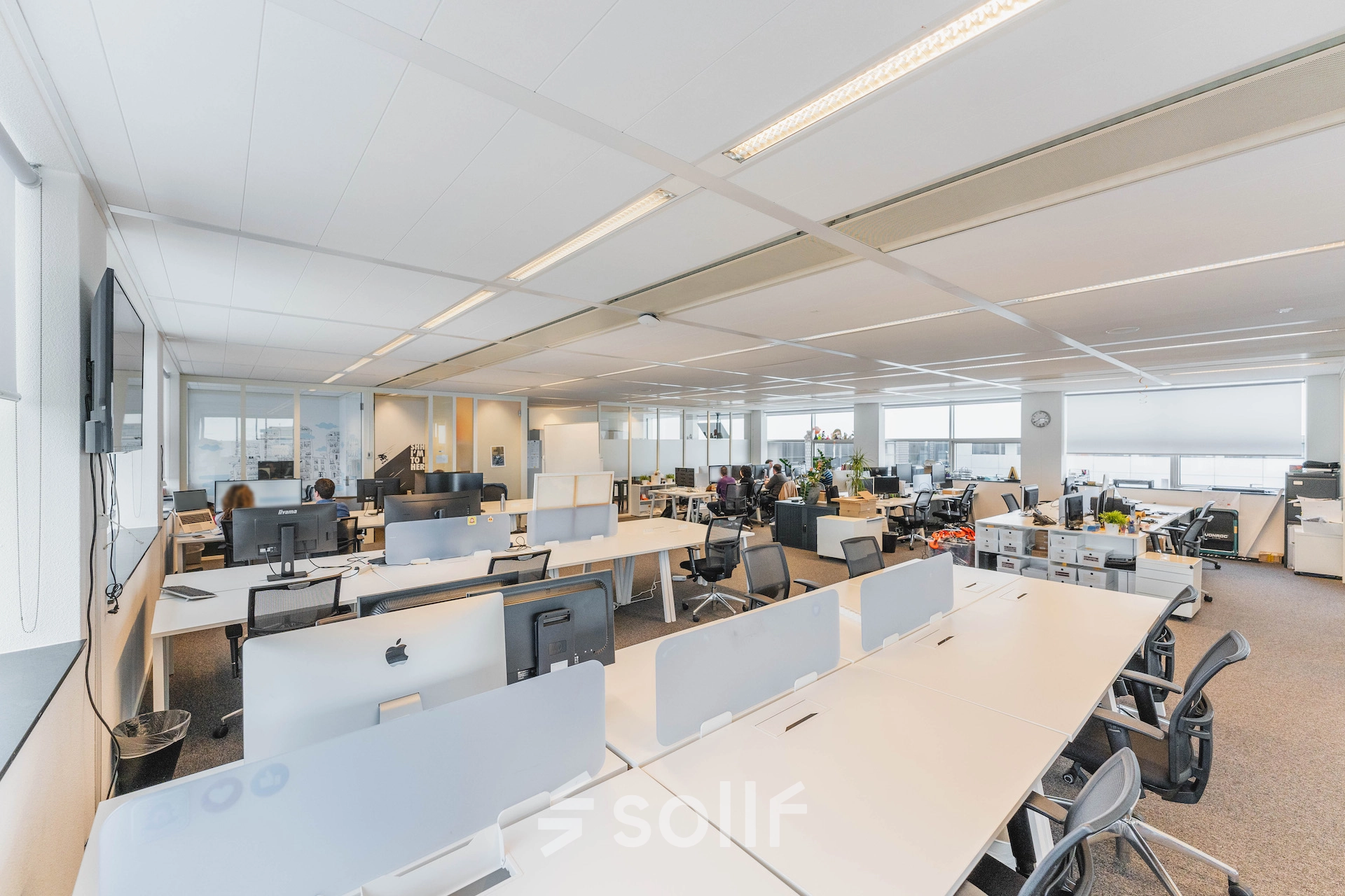 Spacious and well-lit office space in Amsterdam East with modern furnishings and workstations available for rent.