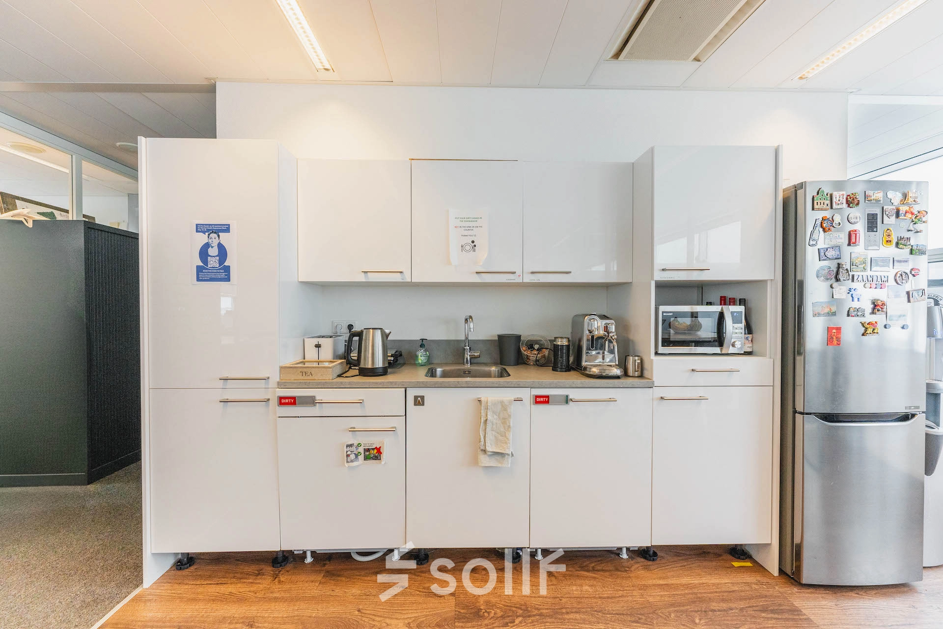 Modern kitchenette in office space for rent featuring appliances and a clean design at Piet Heinkade 95B, Amsterdam East.