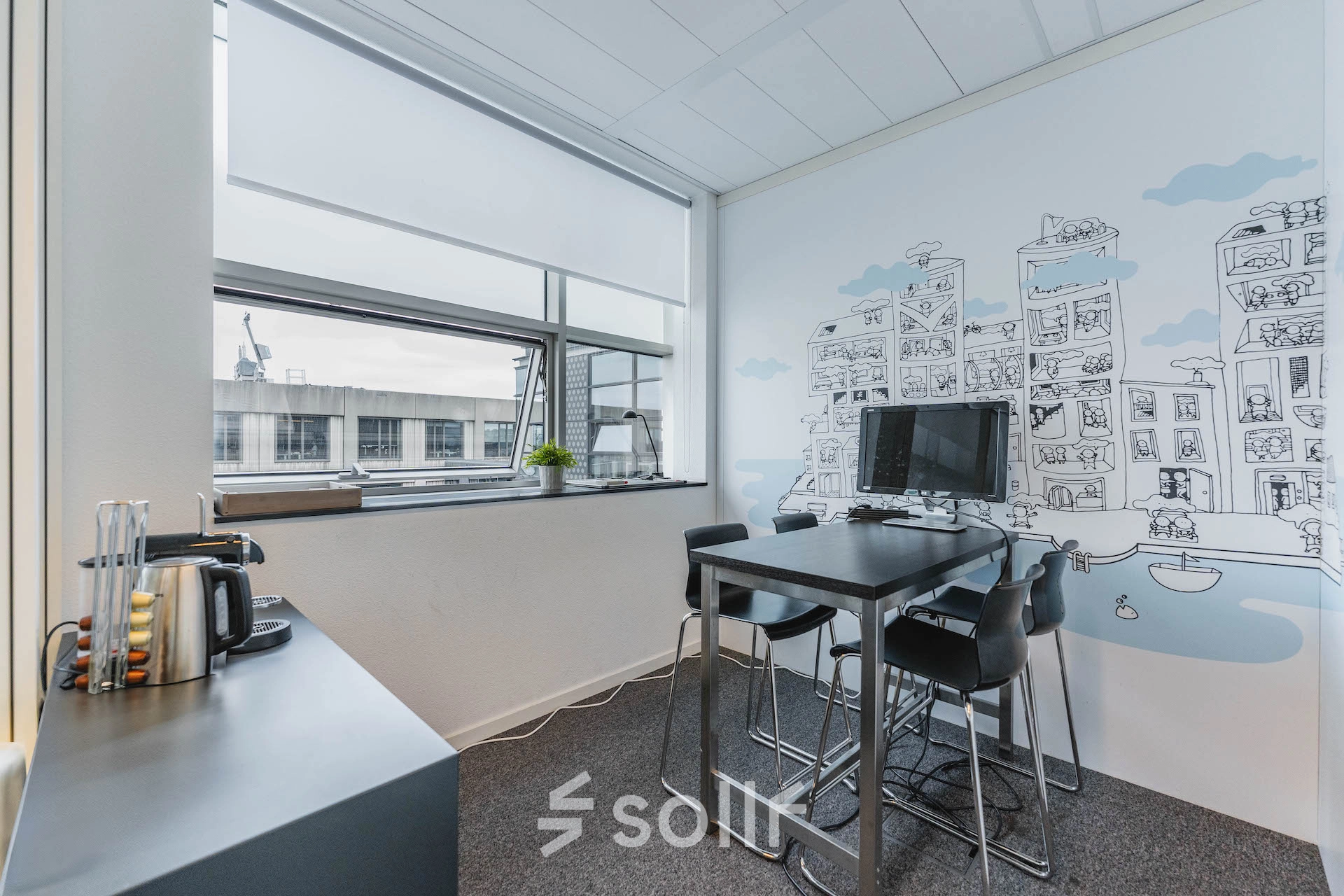 Bright office space at Piet Heinkade 95B, Amsterdam East, featuring modern furnishings and artwork. Ideal for rent office space with ample light and sleek furniture.