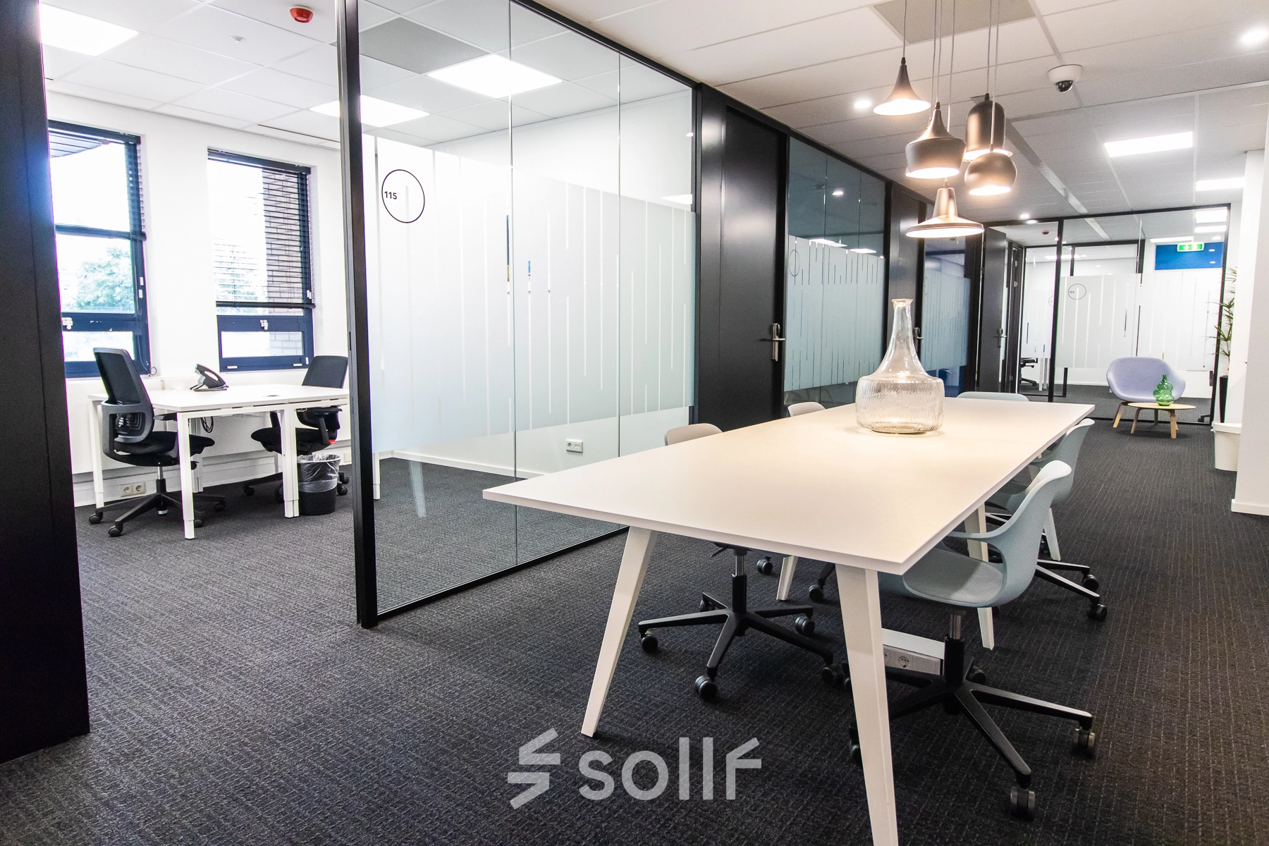 Bright, modern office space at Rhijnspoorplein 10-38 in Amsterdam East featuring sleek desks and contemporary lighting, ideal for office space rental.