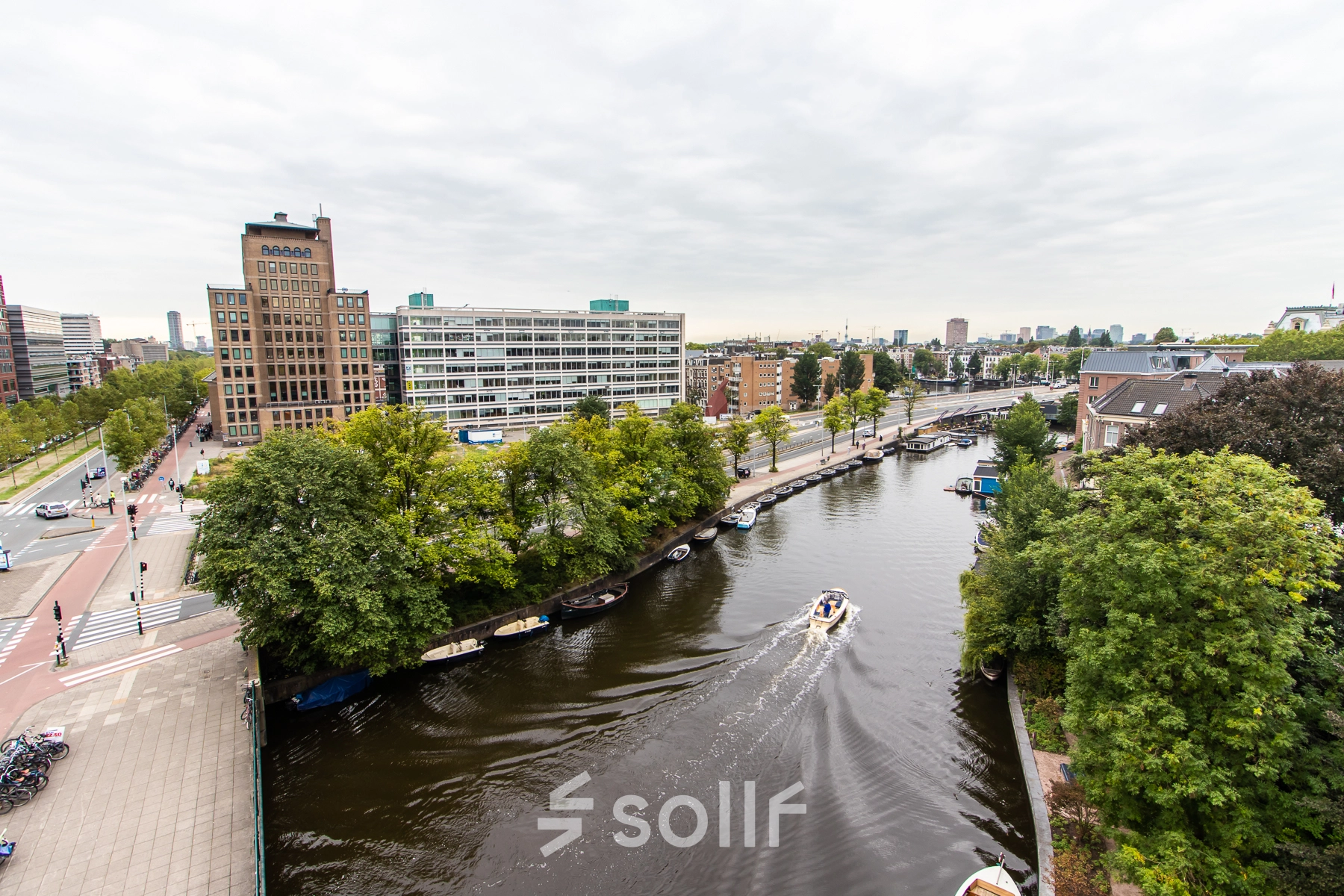 View of Rhijnspoorplein 10-38 in Amsterdam East, showcasing nearby waterways and urban surroundings, ideal for office space rental.