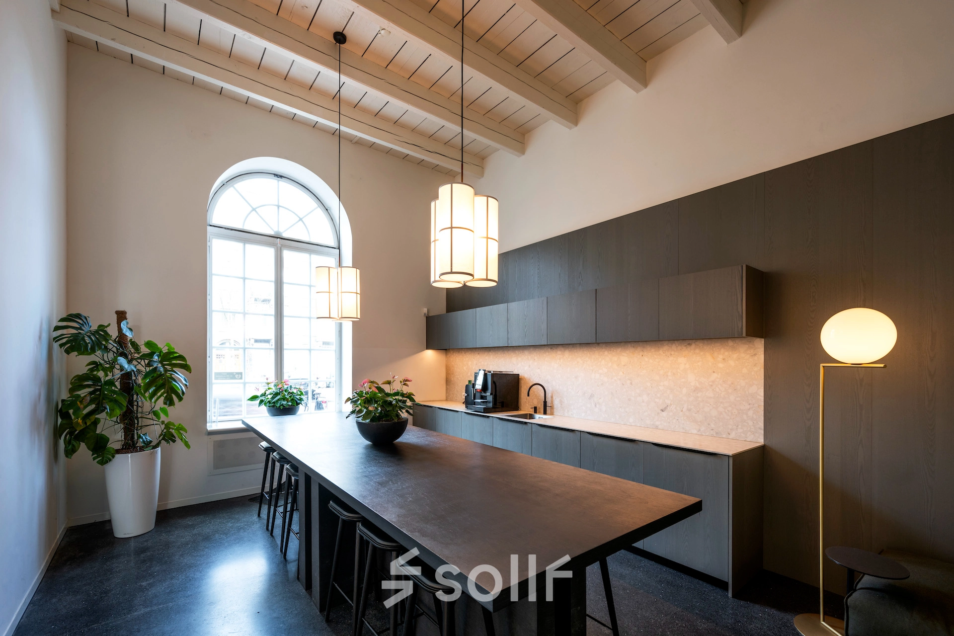 Elegant office space with a long table and chairs, located in Amsterdam East, perfect for meetings or workspace rental.