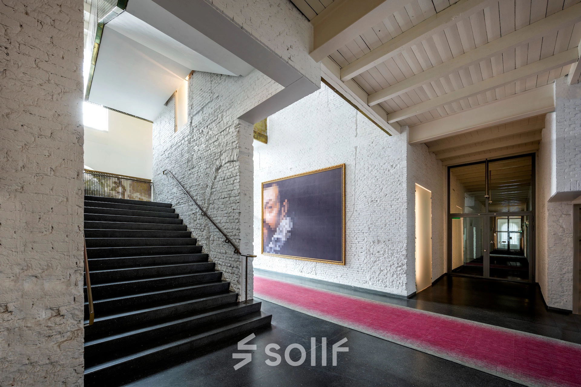 View of the spacious office interior at Sarphatistraat 370, Amsterdam East, with a staircase and modern decor, ideal for office space rental.