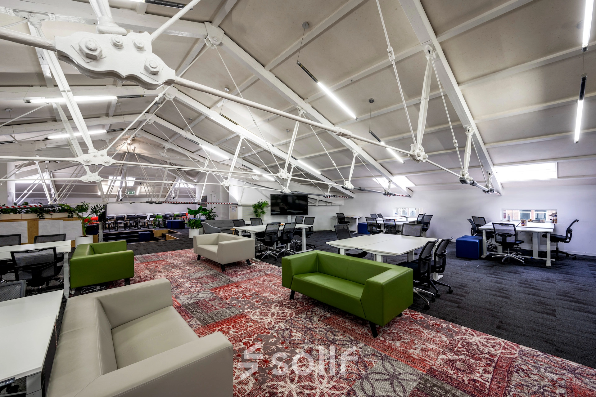 Spacious office to rent on Sarphatistraat 370, Amsterdam East, featuring modern furniture and open workspaces ideal for office space rental.