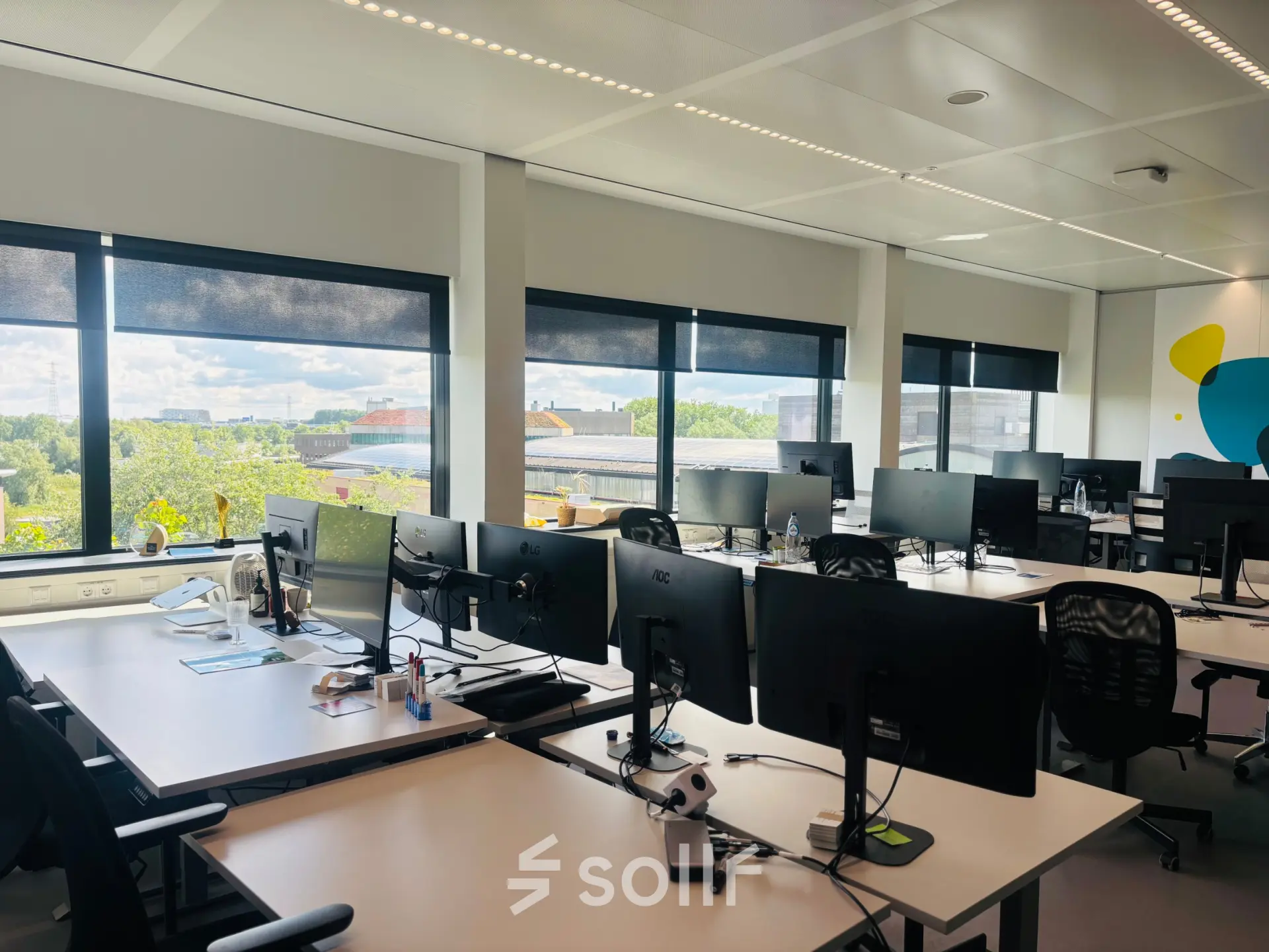 Bright office space for rent with multiple workstations, large windows, and views of Amsterdam East at Science Park 301.