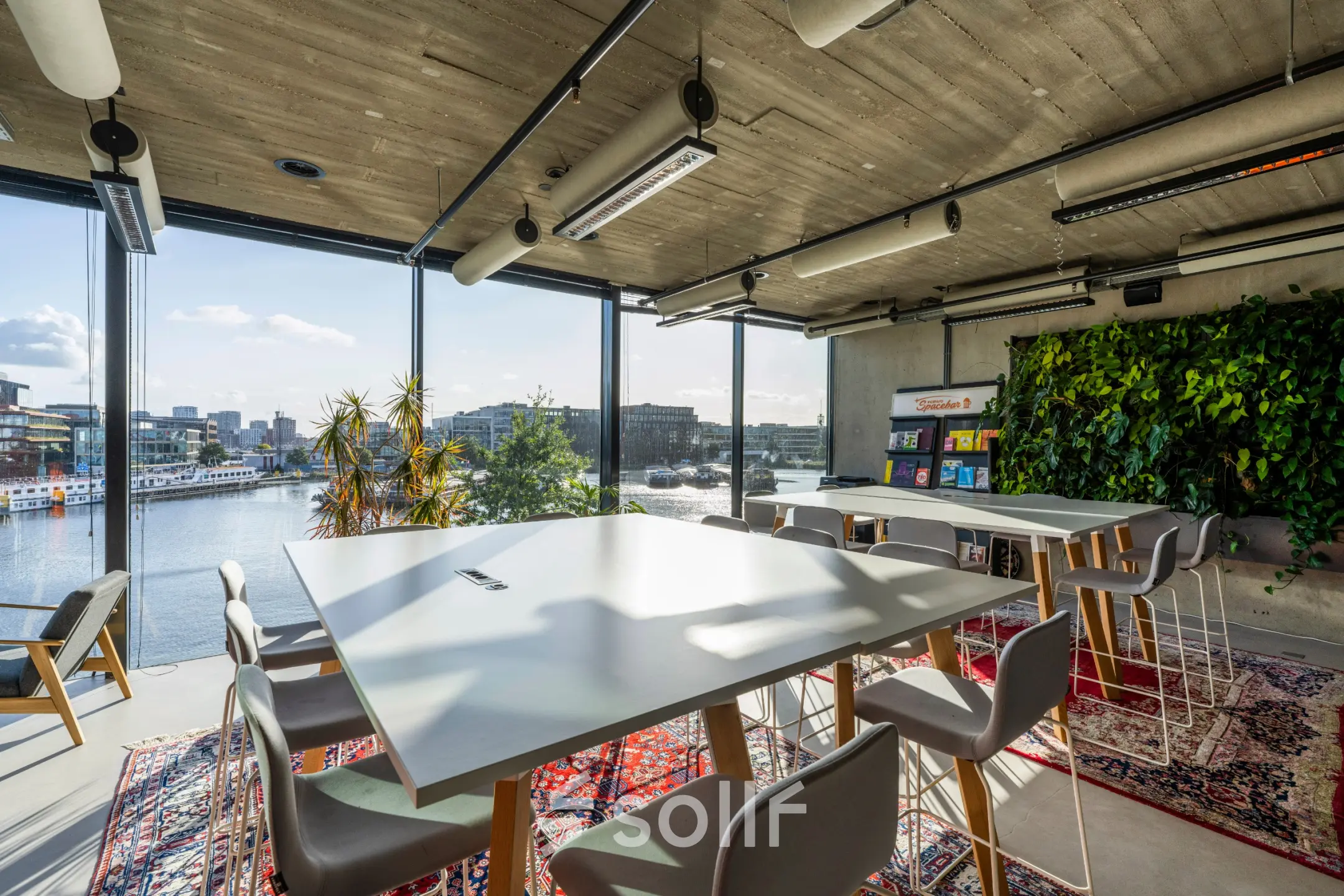 Modern furnished office space for rent with large windows offering views of Amsterdam Houthavens at Moermanskkade 109-113.