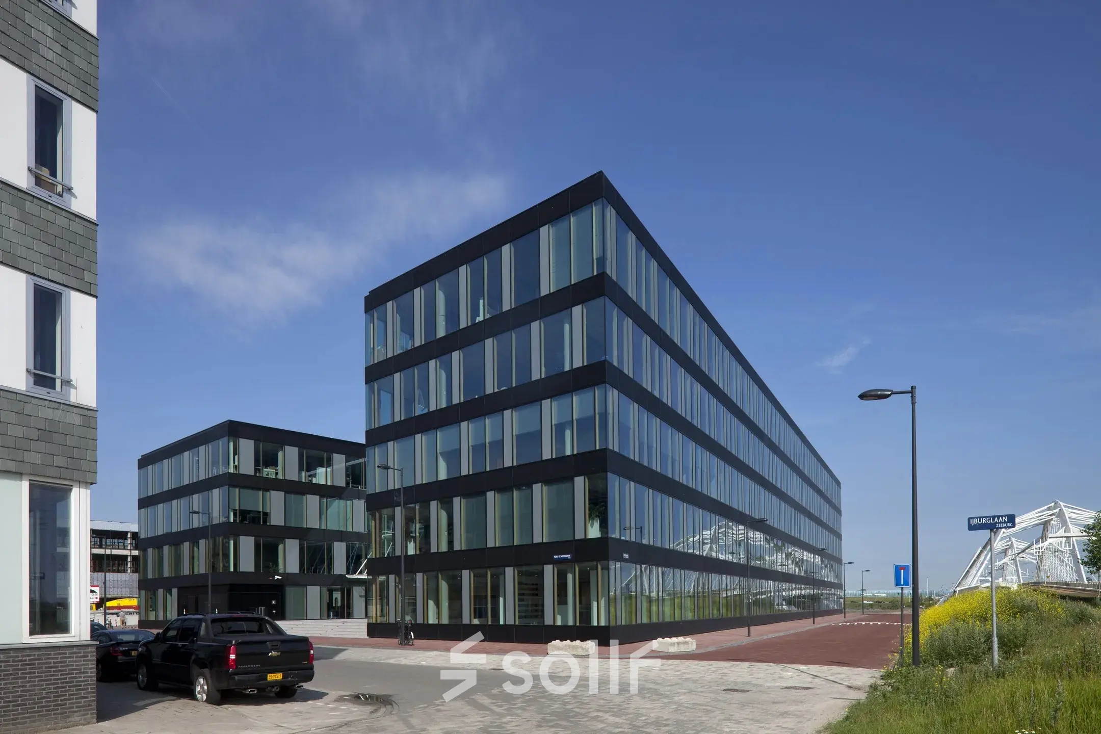Modern office building with large glass windows at Pedro de Medinalaan 7, ideal for those looking to rent office space in Amsterdam IJburg.