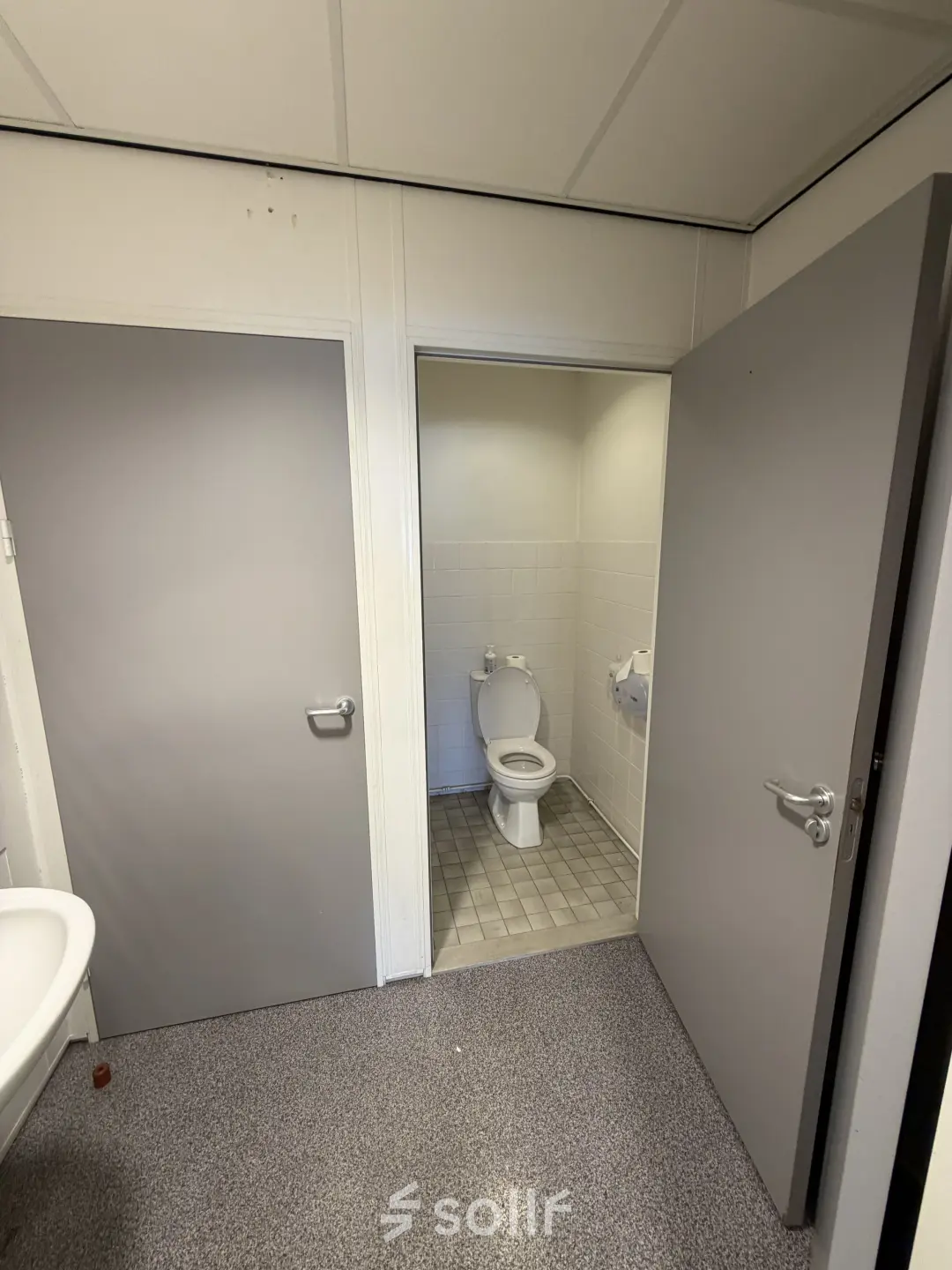 Interior view of a restroom with a toilet and sink, suitable as a part of office space rental at Buikslotermeerplein 430, Amsterdam North.