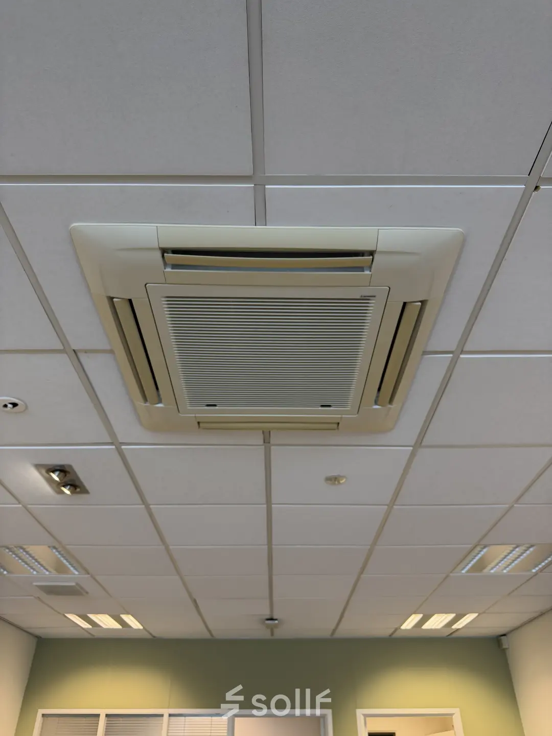 Ceiling view in an empty office space with tiled panels and ceiling air conditioning at Buikslotermeerplein 430, Amsterdam North.