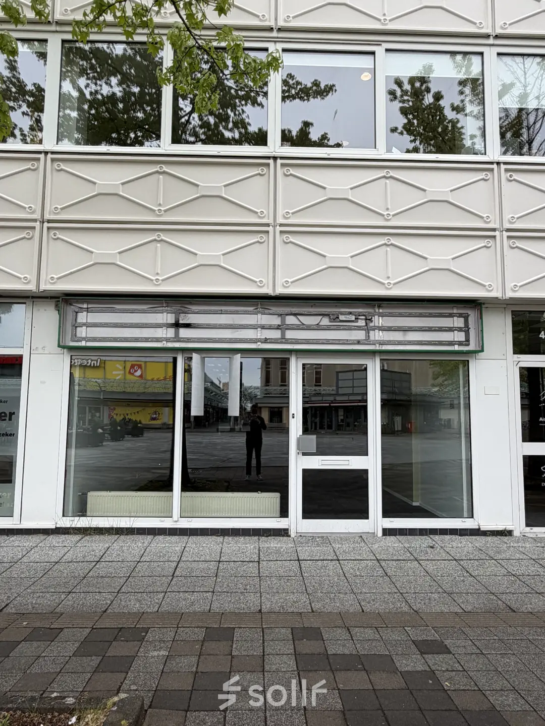 Exterior view of the office building at Buikslotermeerplein 430, Amsterdam North featuring modern facade with large windows, available for office space rental.