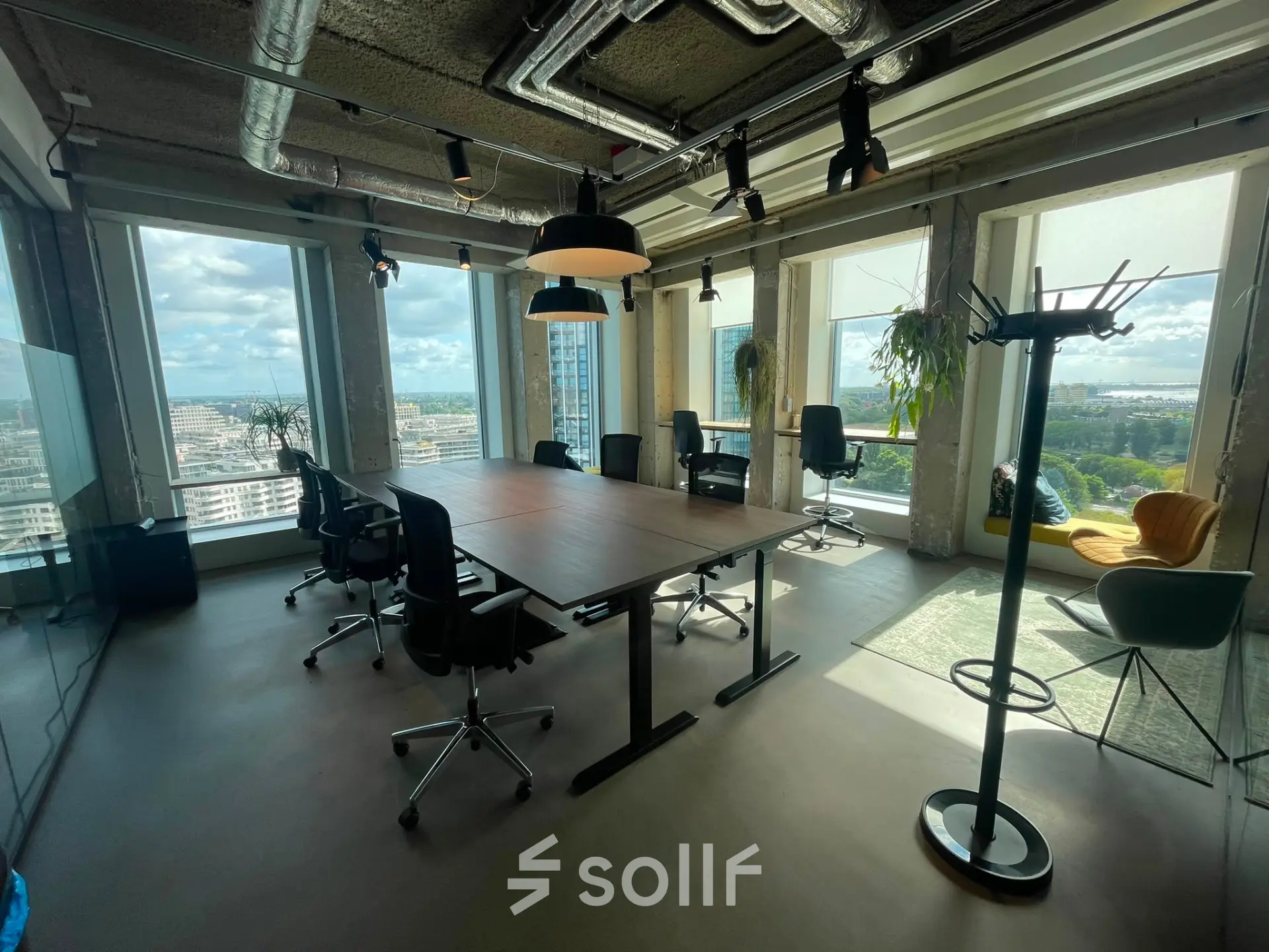 Spacious office with panoramic windows at Overhoeksplein 1, featuring desks and chairs for business activities. Ideal for office space rental in Amsterdam North.
