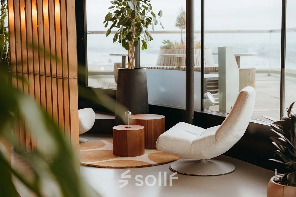 Rent office space at Overhoeksplein 1, Amsterdam North: A stylish lounge area with modern seating and a panoramic view.