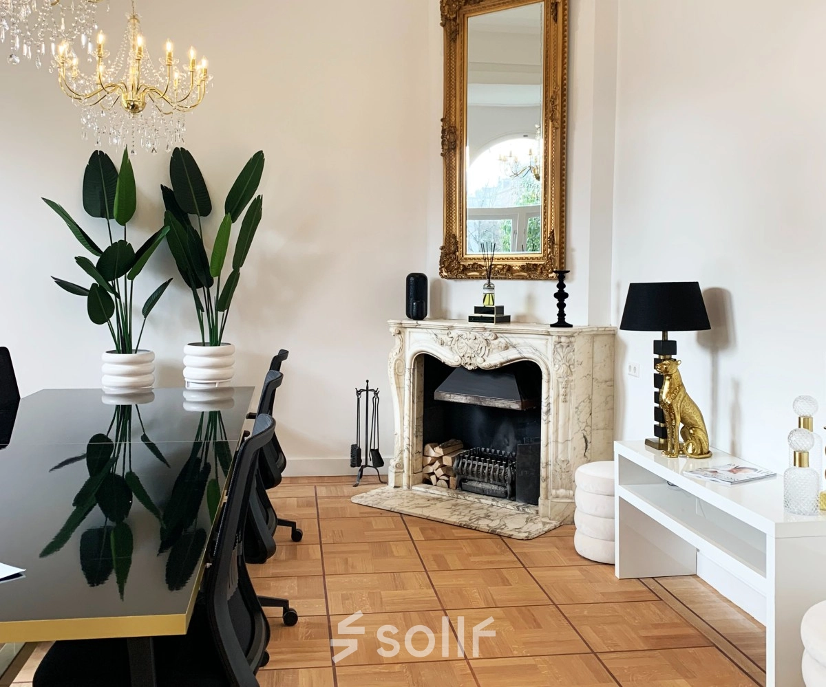 Elegant office space available for rent in Amsterdam Old South, featuring a stylish conference table, decorative fireplace, and chic furnishings at Emmalaan 7-9.