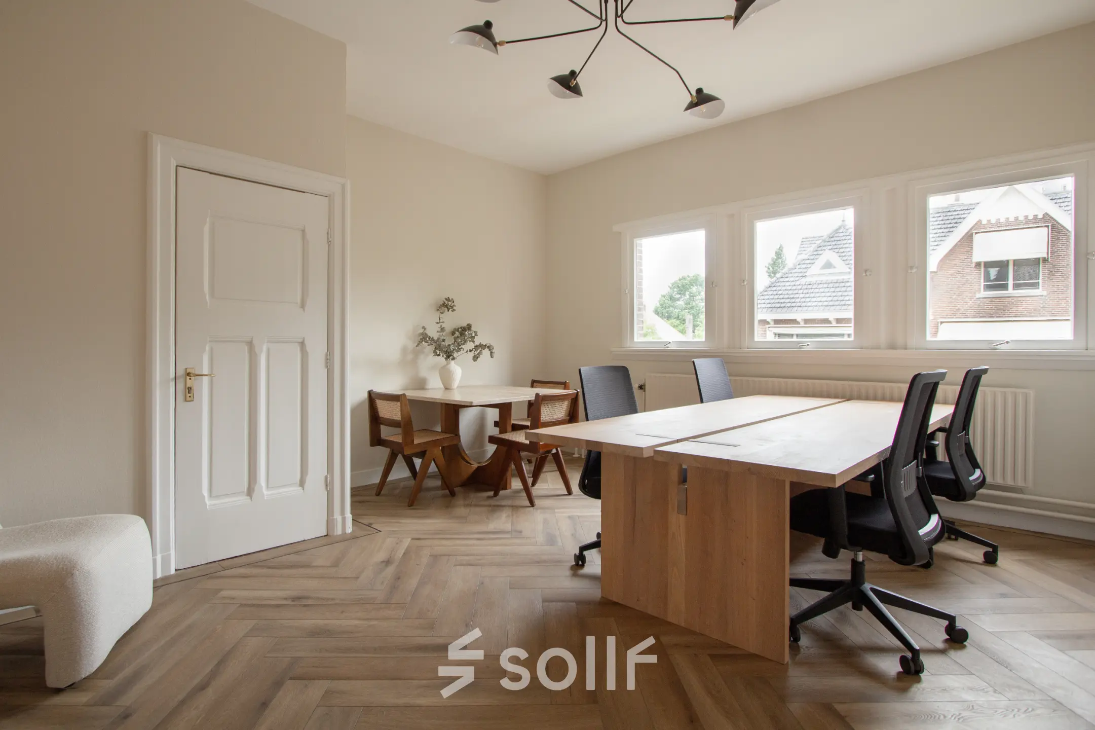 Bright furnished office space rental at Emmalaan 7-9, featuring natural light and a stylish meeting area. Ideal office to rent in Amsterdam Old South.