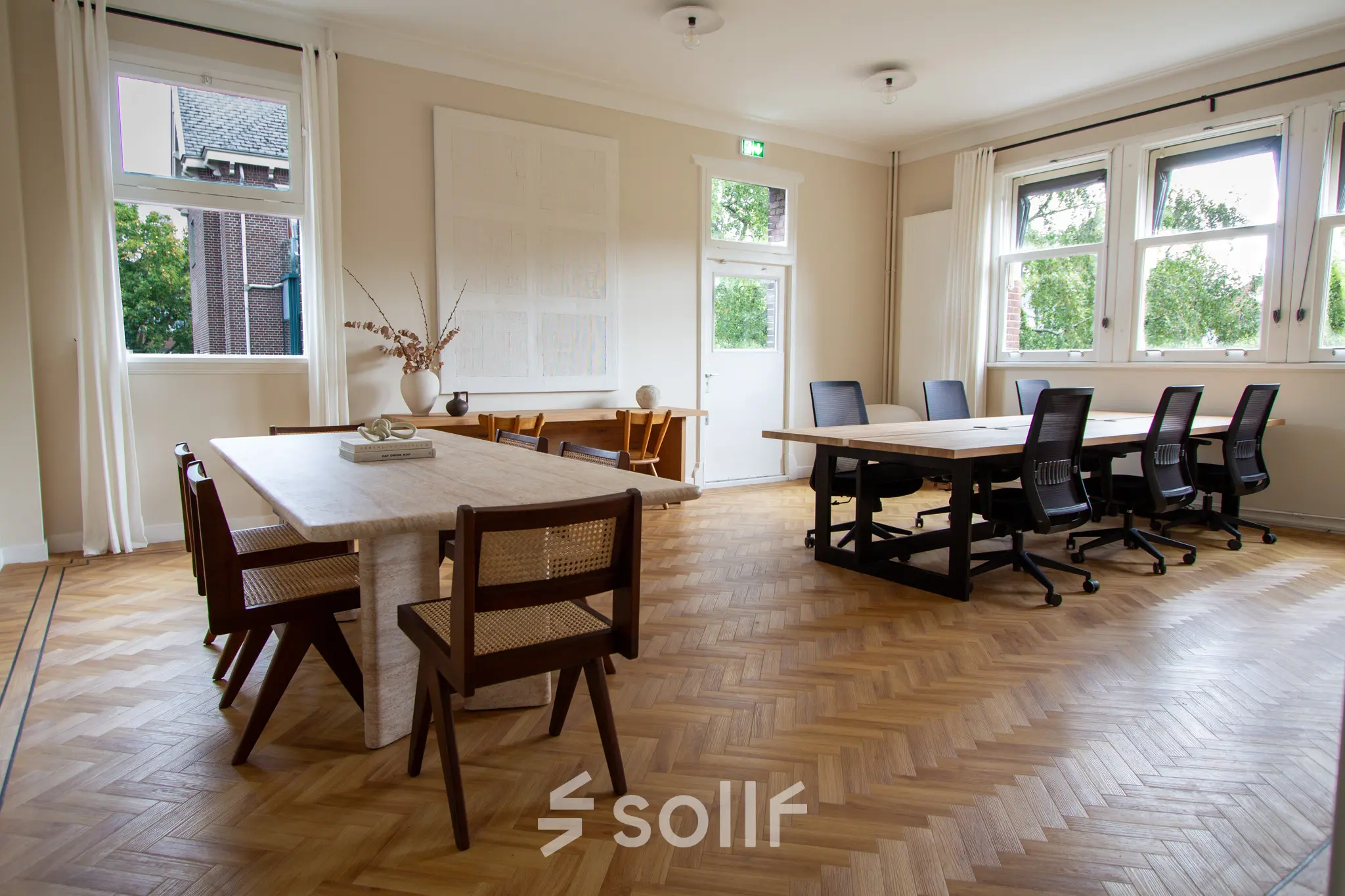 Bright, spacious office at Emmalaan 7-9 in Amsterdam Old South, featuring parquet flooring and modern furnishings. Ideal for rent office space with ample natural light and stylish seating.