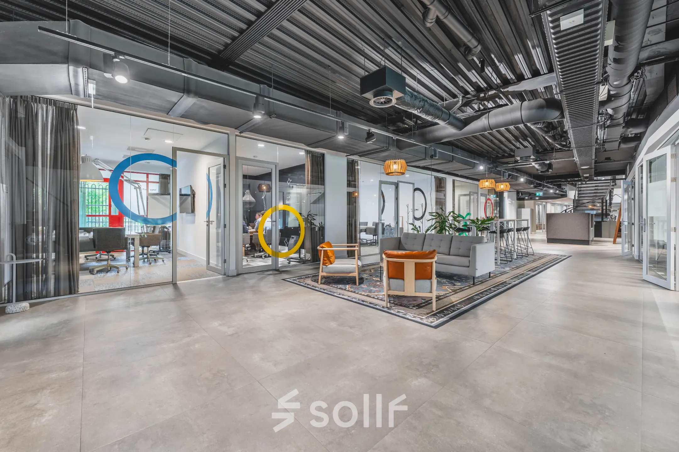 Stylish office space for rent at Olympisch Stadion 24-28, Amsterdam Old South, featuring modern furnishings, seating areas, and meeting rooms with colorful accents.