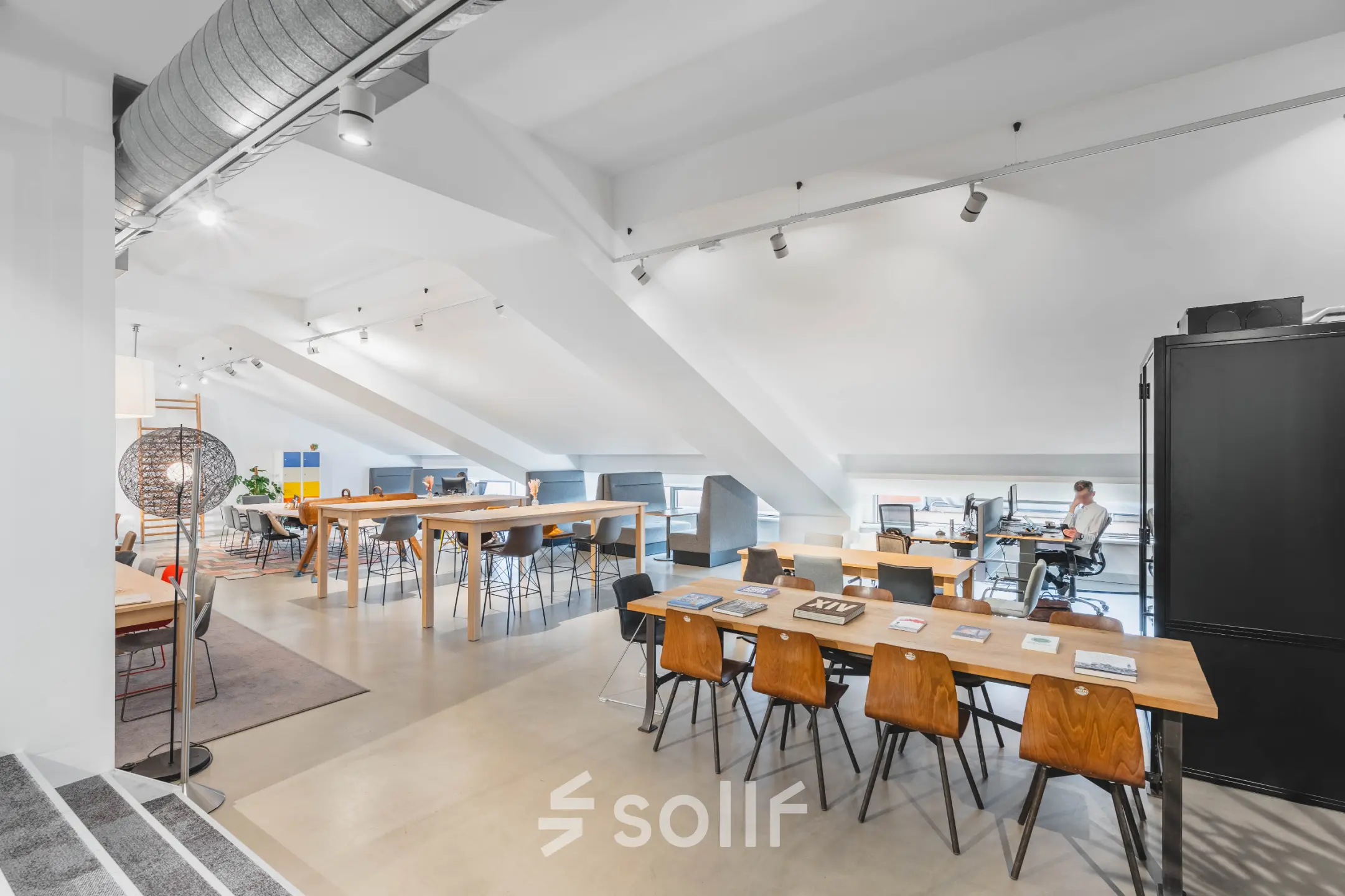 Bright office space at Olympisch Stadion 24-28, Amsterdam Old South, featuring modern workstations with people working. Ideal for office space rental.