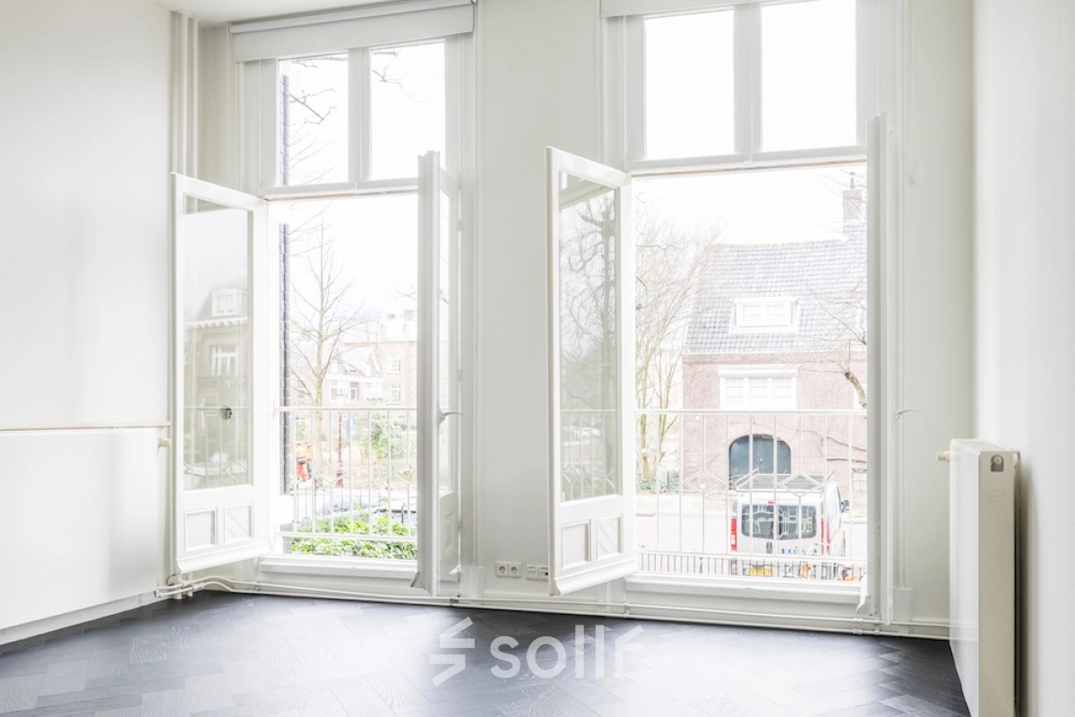 Bright office to rent at Sophialaan 21, Amsterdam Old South, featuring large windows with views of a charming street, perfect for office space rental opportunities.