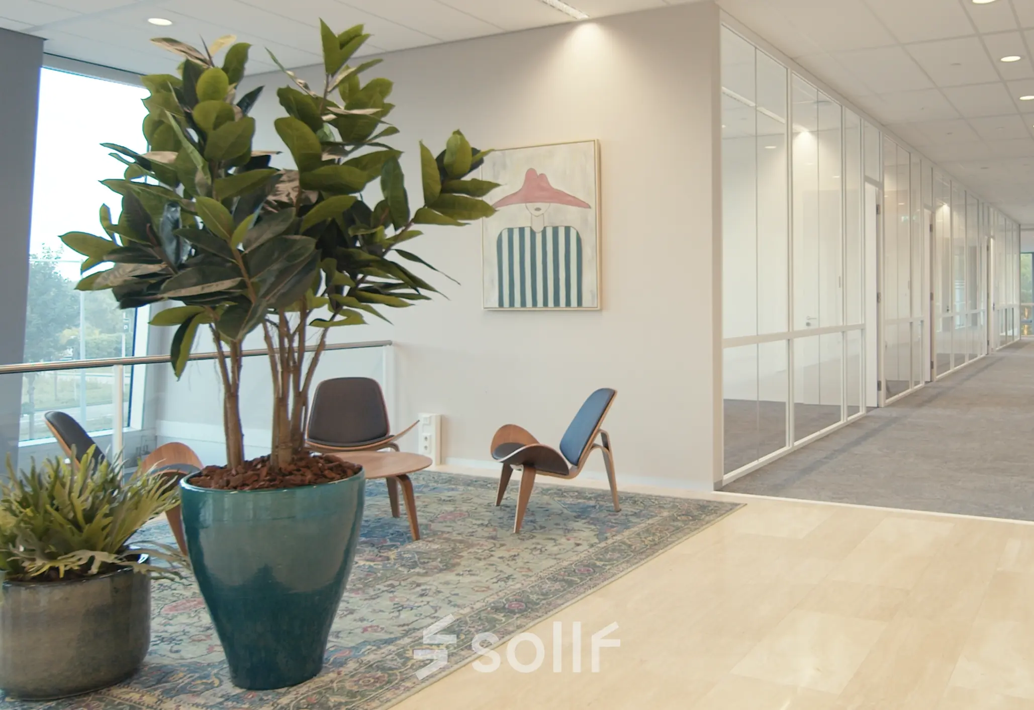 Spacious office entrance at David Ricardostraat 1 in Amsterdam Riekerpolder, featuring modern furnishings and vibrant decor. Ideal office space rental with comfortable seating area.