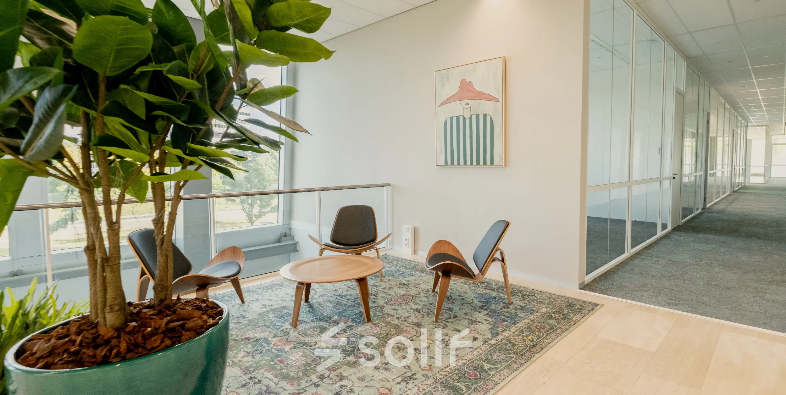 Bright office space with modern furnishings, featuring a seating area with chairs and a table, located at David Ricardostraat 1 in Amsterdam Riekerpolder. Ideal for office space rental opportunities.