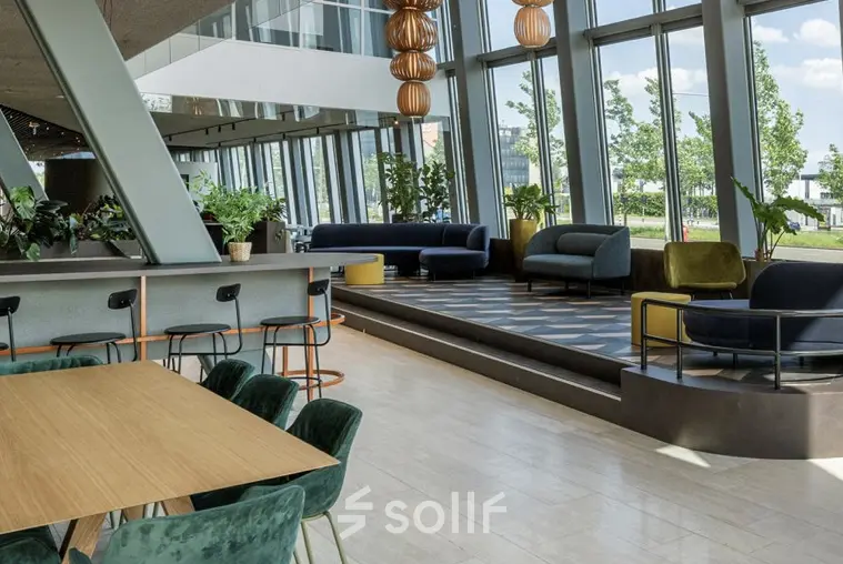 Spacious and modern office space with stylish furniture and large windows at David Ricardostraat 1, Amsterdam Riekerpolder, perfect for office space rental.